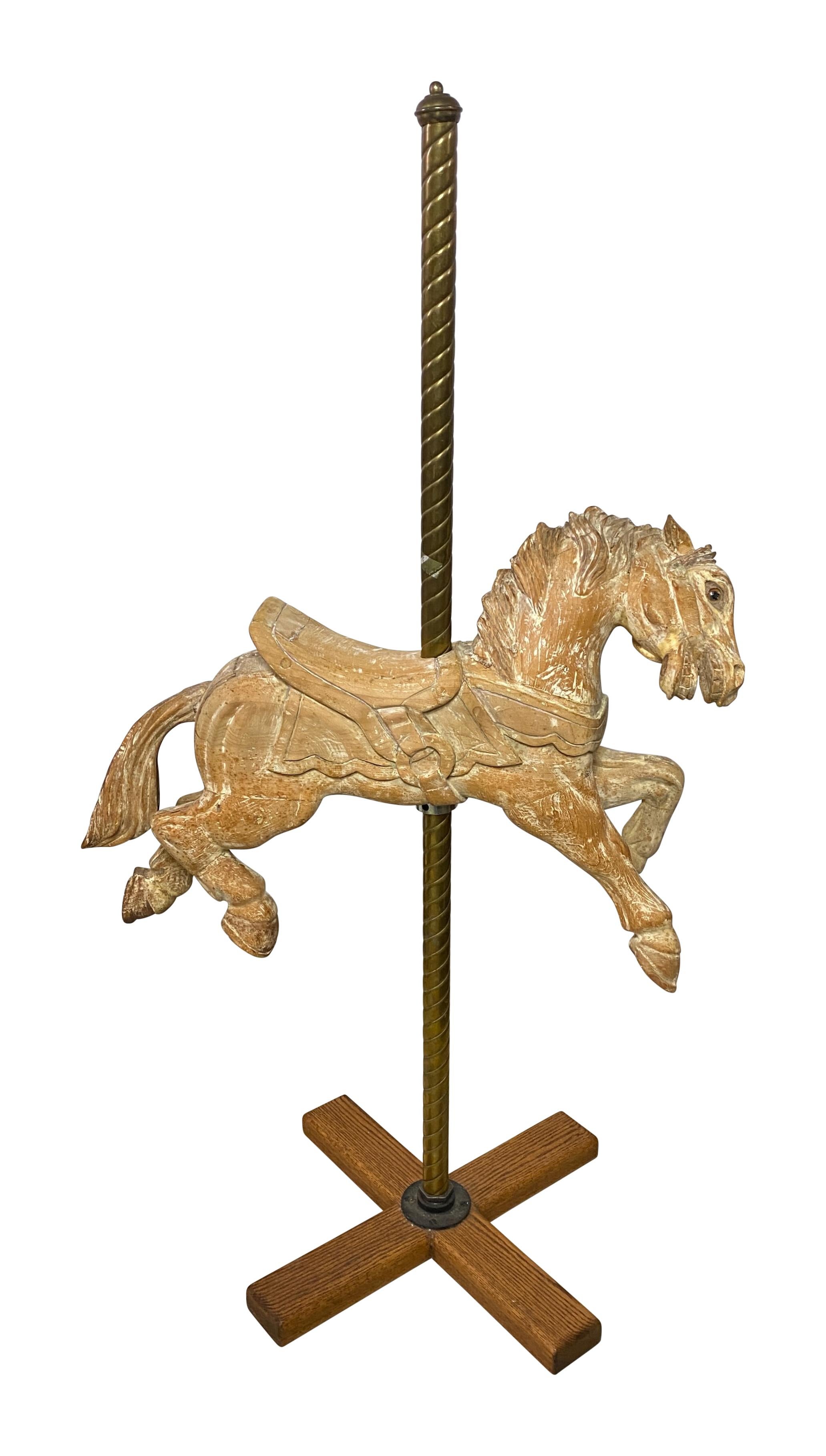 Cheval de carrousel ancien en bois sur un support en laiton fait sur mesure. 
Sculptée de façon experte avec de merveilleux détails.
Peint à l'origine mais débarrassé de la plupart de ses anciennes peintures à un moment donné.
Fabriqué dans la