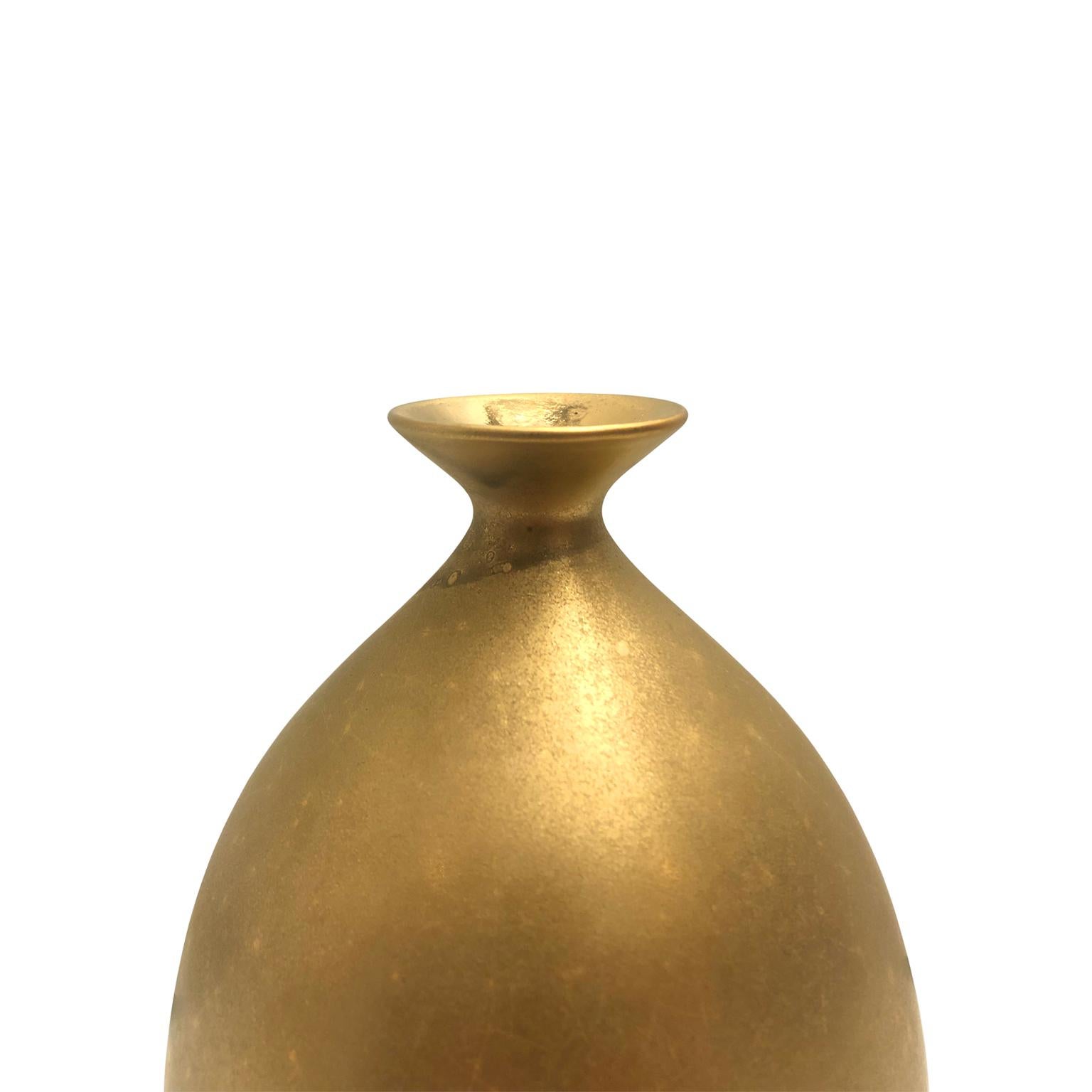 Small ceramic bottle vase with burnished gold lustre glaze by Sandi Fellman, 2019. 

Veteran photographer Sandi Fellman's ceramic vessels are an exploration of a new medium. The forms, palettes, and sensuality of her photos can be found within