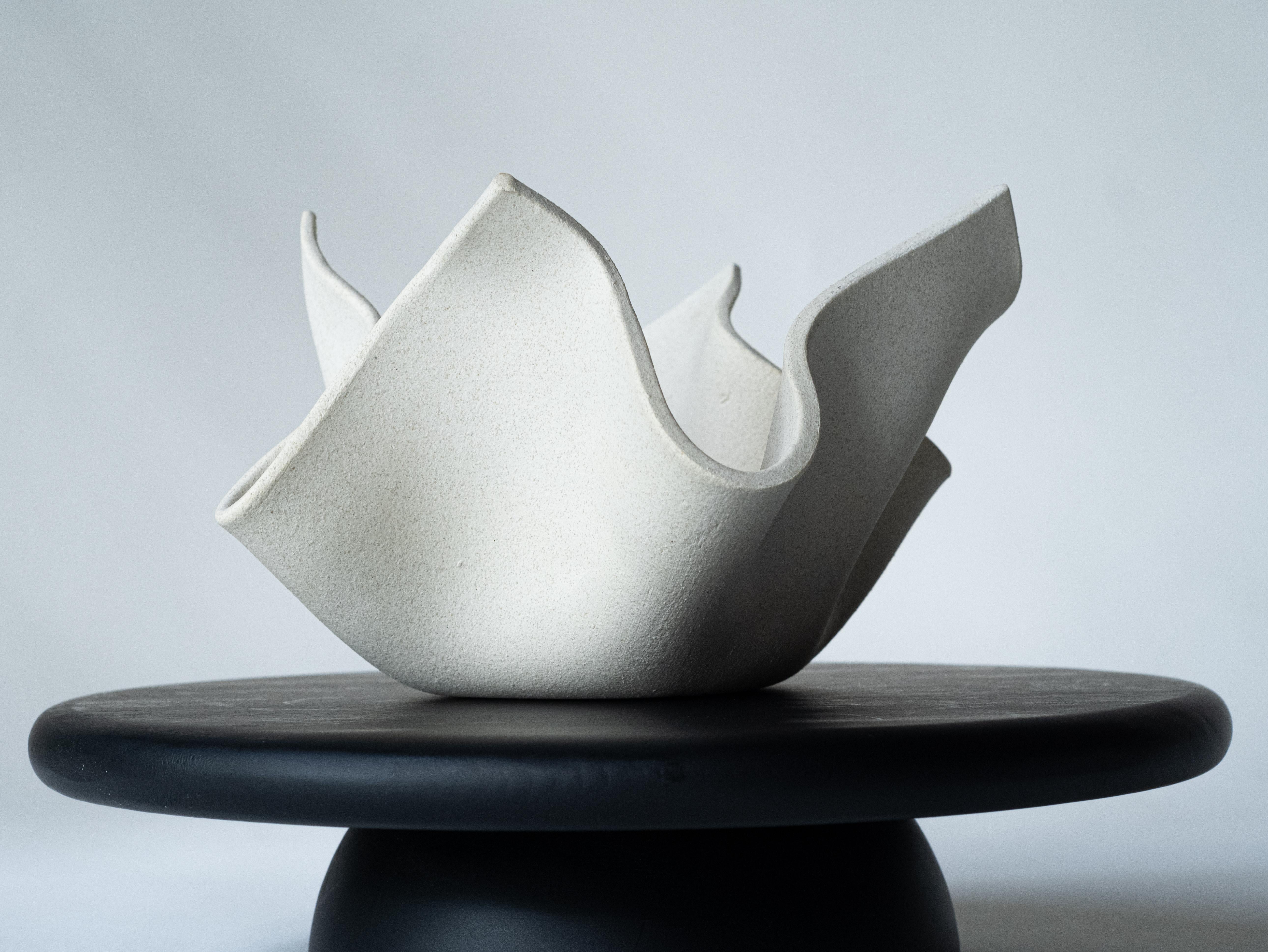 Exquisitely crafted, our windswept bowl is a testament to artisanal excellence. Meticulously handmade by skilled artisans in our studio, it emerges from pure white clay, resulting in a stunning aesthetic. Its versatility shines as it can serve as a