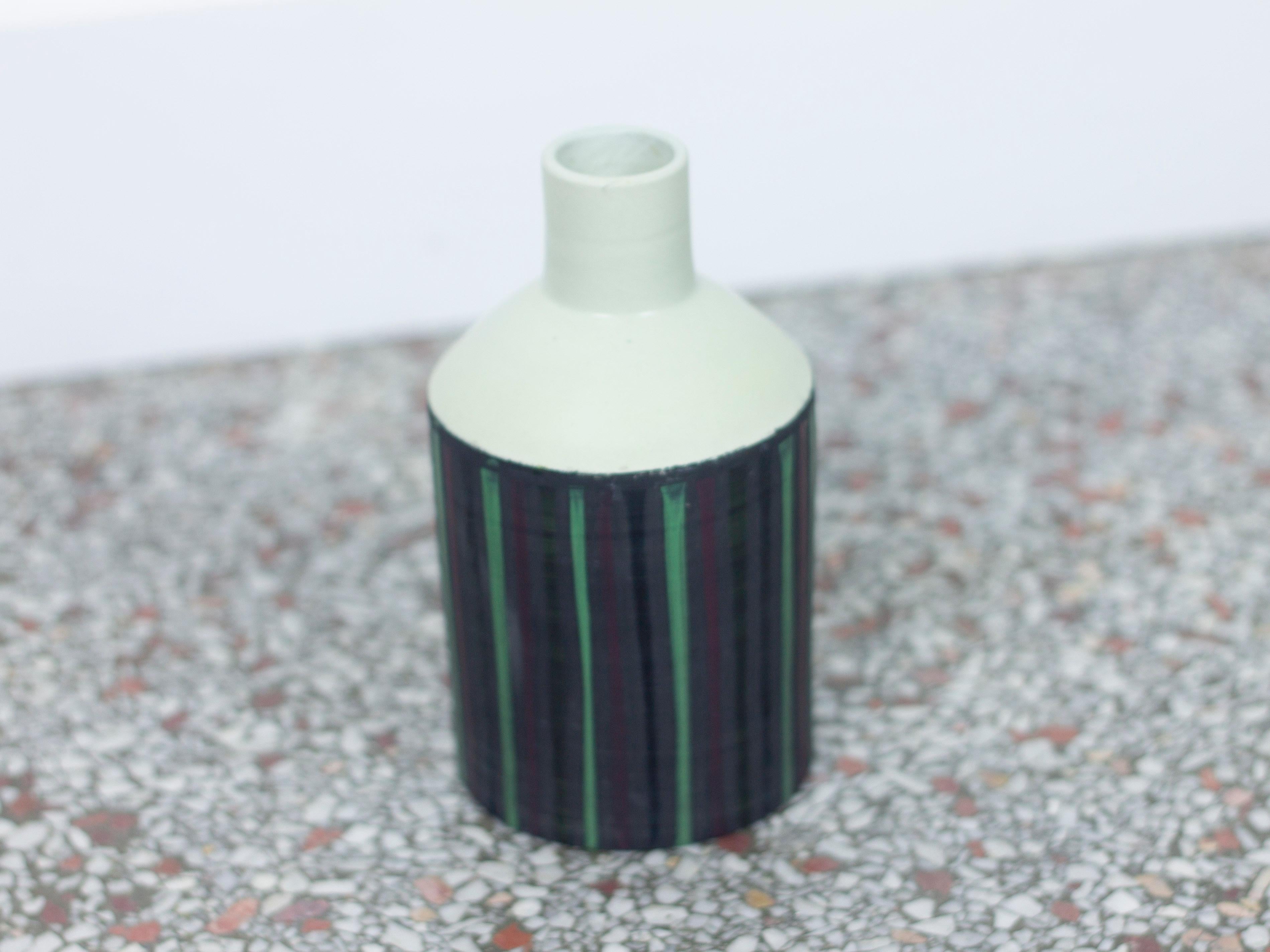 A small ceramic vase or bottle with green and purple pinstripe glaze designed by Ettore Sottsass for Bitossi. Aquired from the Miami estate of a former Easter Airlines pilot. Signed 