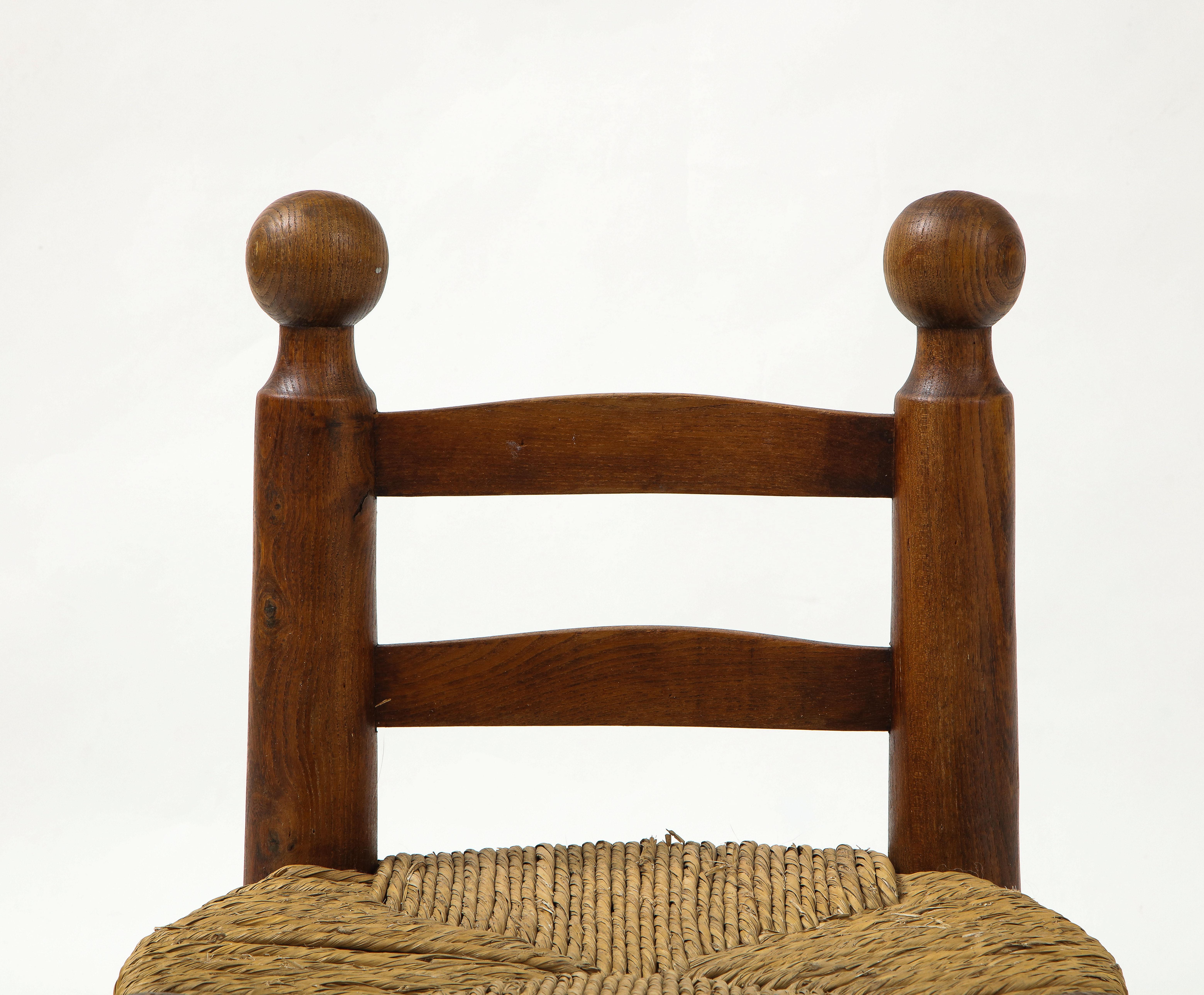 Small chair with rush seat and large ball finials, probably Charles Dudouyt, France, circa 1940
Oak, rush
Measures: Height back 23.75, seat H 11.25, W 17.5 D 15 in.