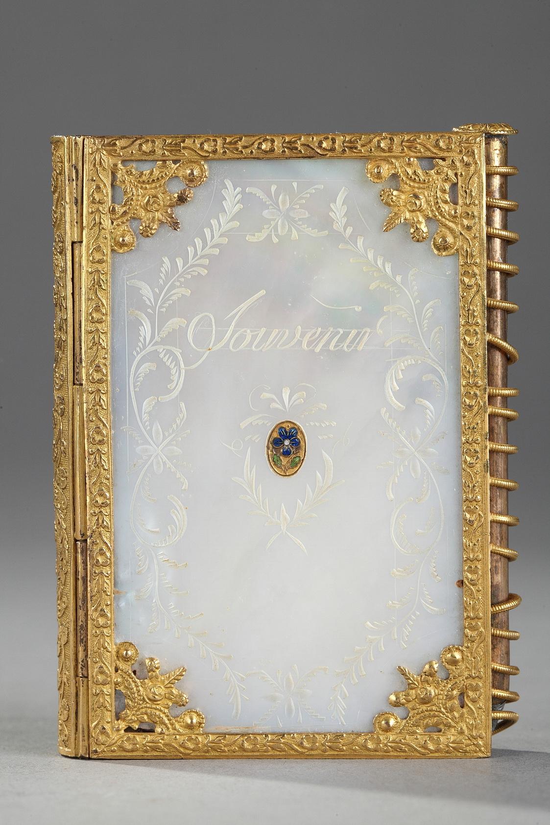 A small Charles X ball notebook in mother-of-pearl and ormolu chiselled with flowers and flowery interlacings. Engraved in French 