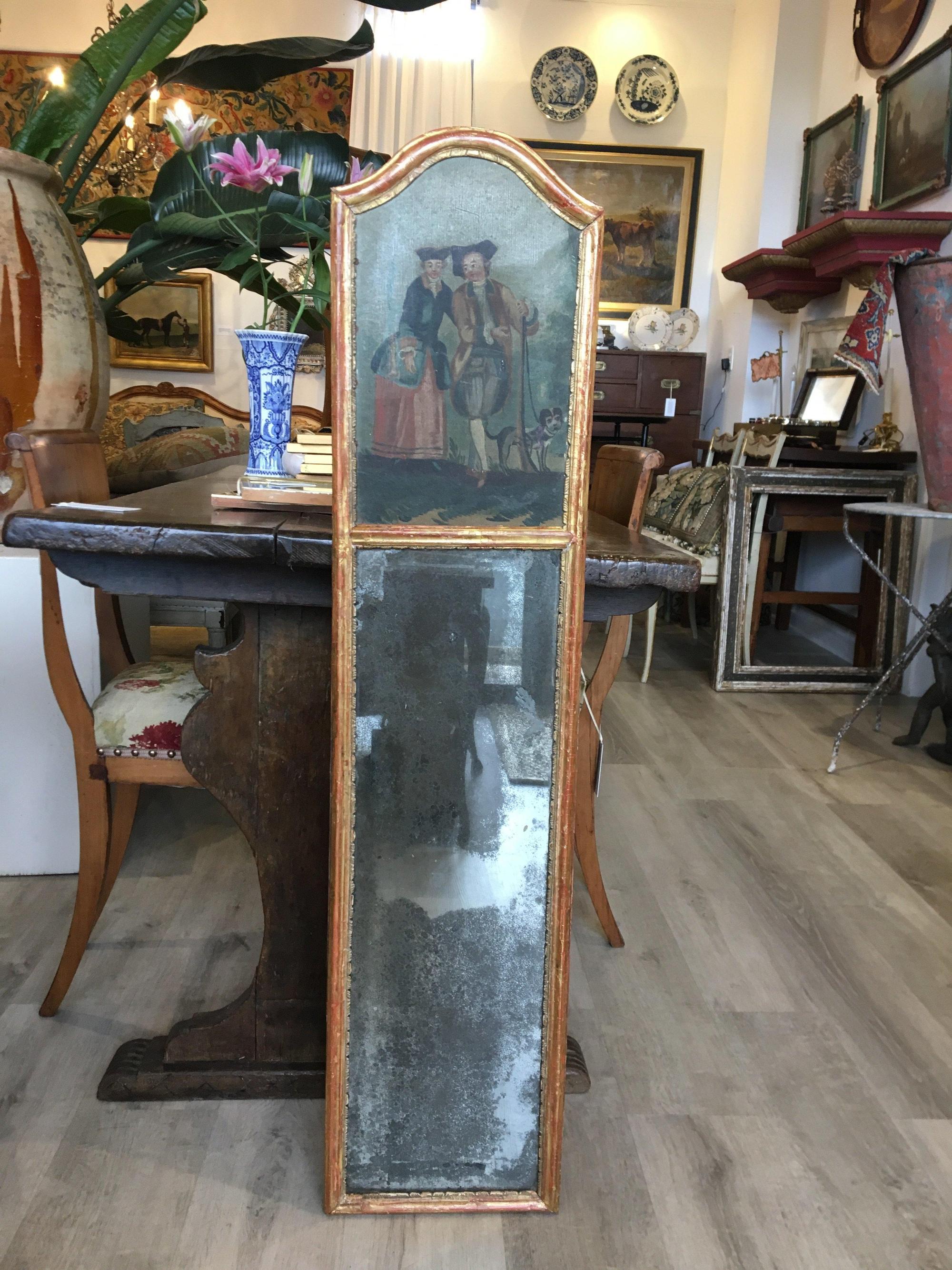 18th century French petit trumeau mirror, charming oil on canvas painting above original long mirror plate, carved and gilded frame. Some repairs to the painting as can be seen in the photos.