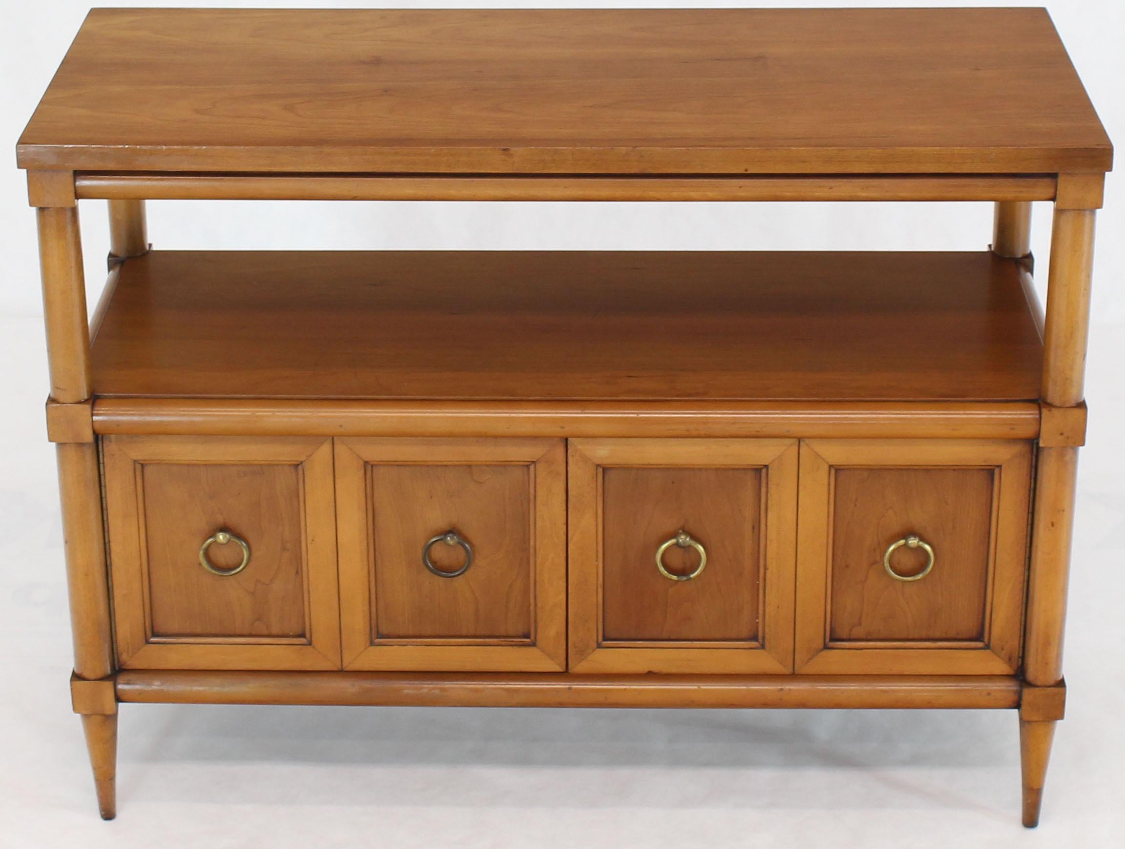 Mid-Century Modern two-tier console table with gibing looking round brass pull by Lane. Two-door storage compartment.
 