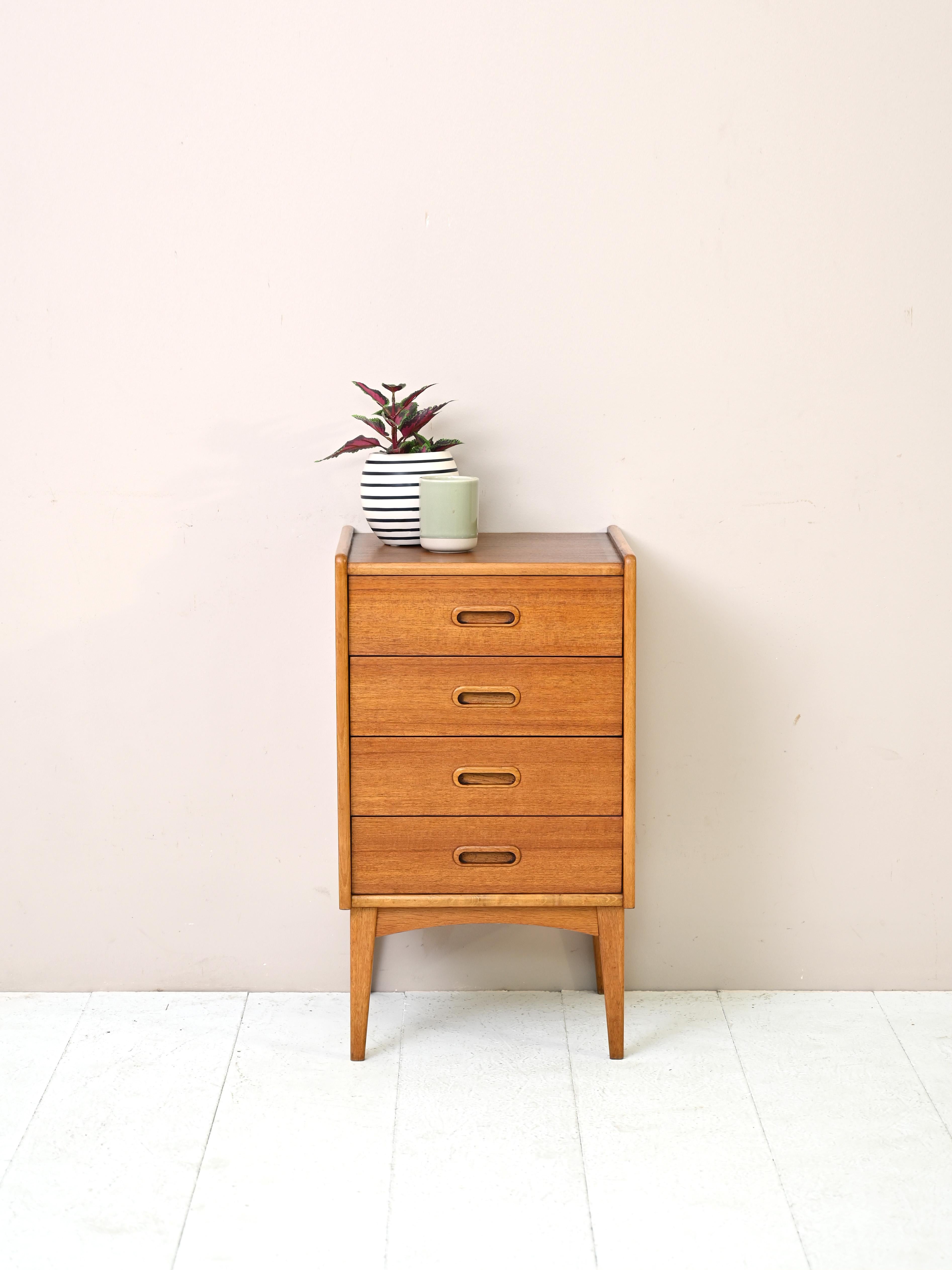 Modernist chest of drawers made in Scandinavia in the 1960s.
Simple and compact this Nordic design piece features four drawers with the handle carved
in the wood.
Ideal as a bedside table or storage unit for the entryway or bathroom.

Good