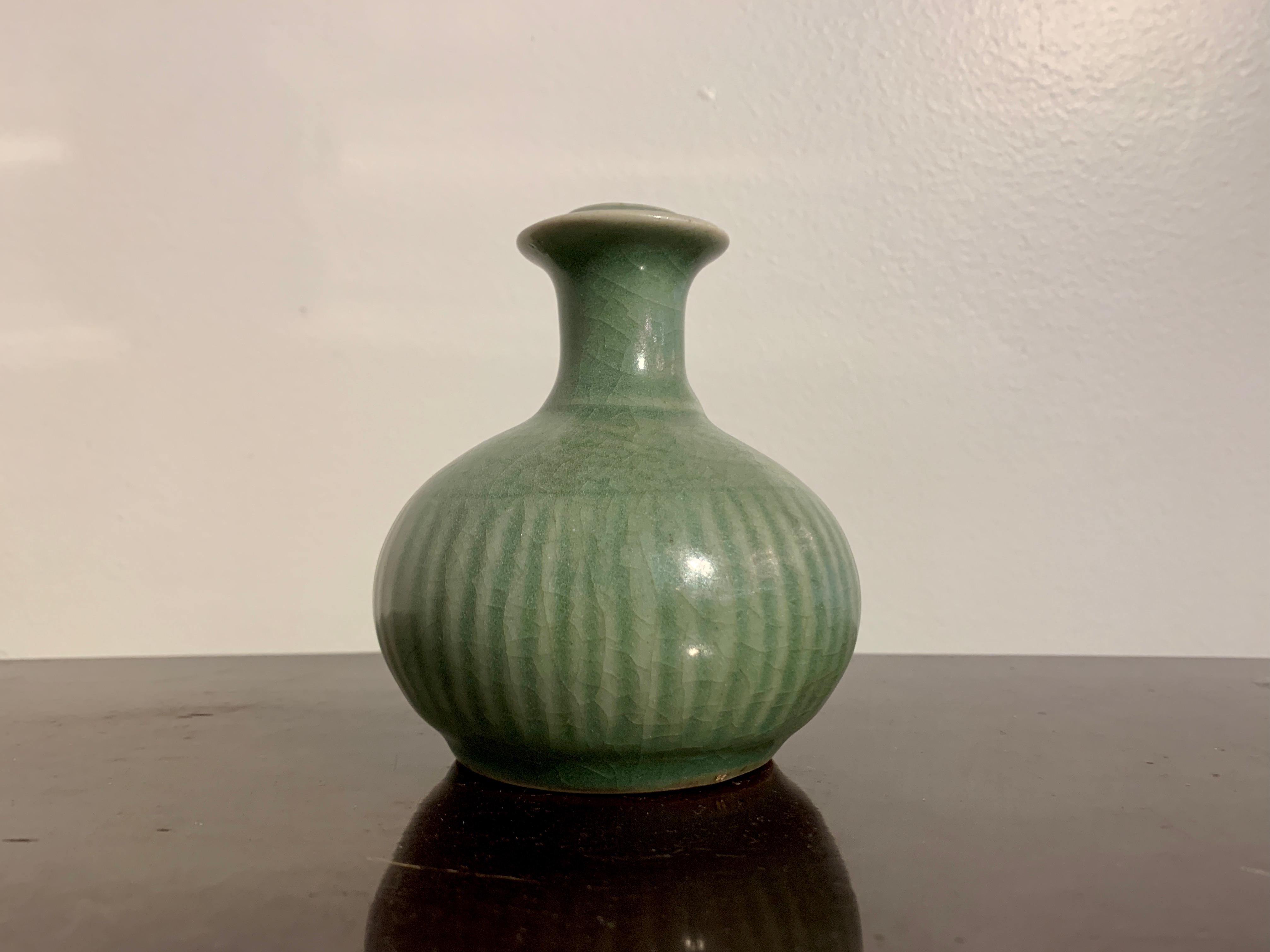 A darling small Chinese celadon glazed kendi, or pouring vessel, mid Qing Dynasty, 18th century, China, for the Southeast Asian market.

The diminutive kendi of typical form, with a globular body, short neck, flanged mouth and large, voluptuous