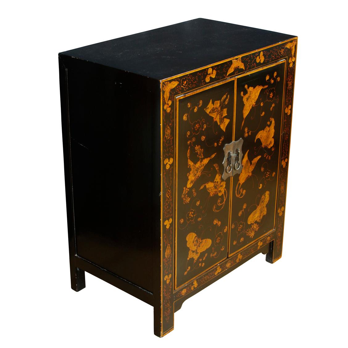 A small storage cabinet painted black with chinoiserie decoration on doors. The piece is a nice size, and can be used as a side table or nightstand. The doors open to reveal and inner storage area with one shelf.