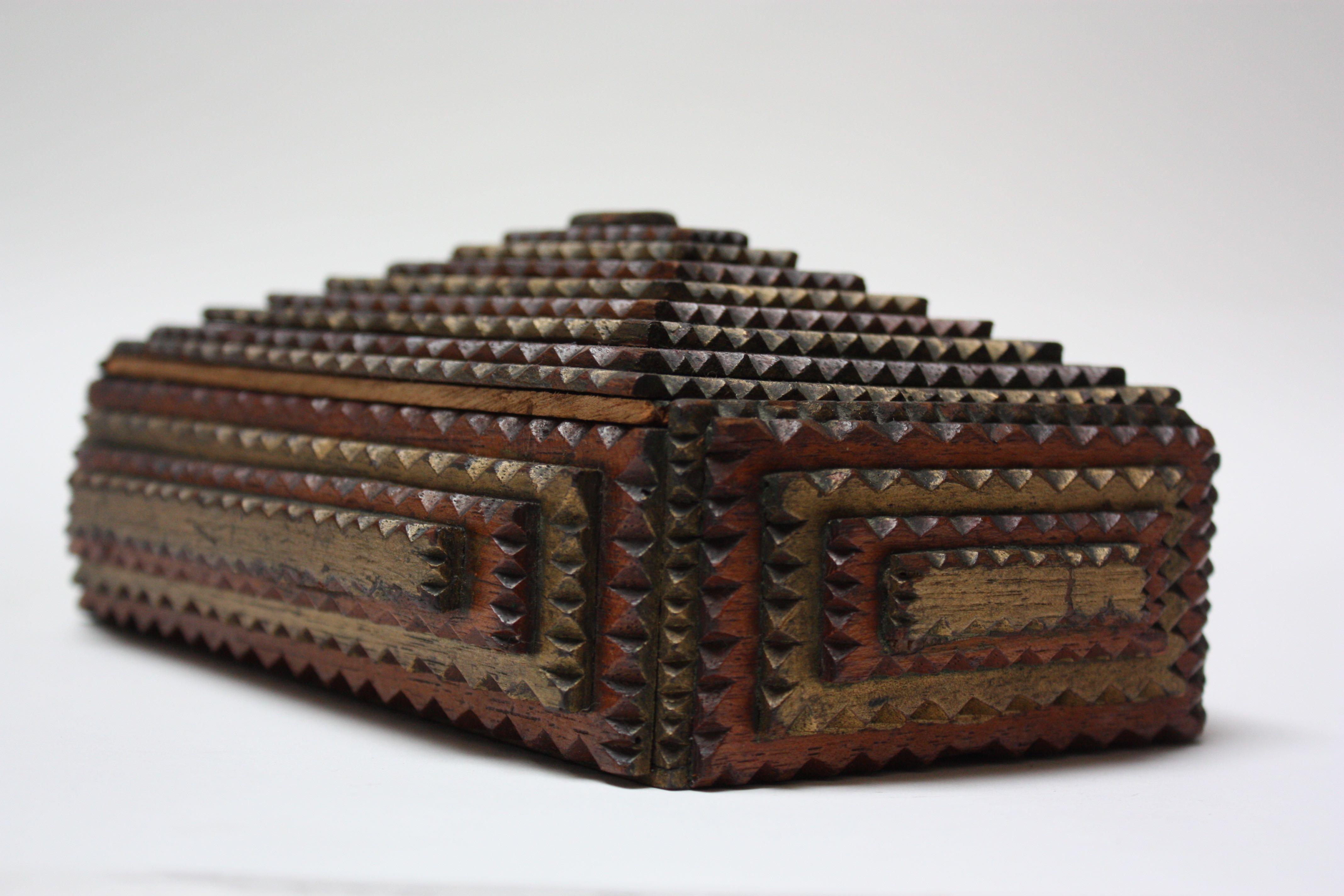 Keepsake American tramp art box (circa 1920-1930) with hand chip-carved wooden decoration in a stepped / pyramidal design. Exterior is in nice condition for its age with the less common hand painted colors, showing only minor paint loss and