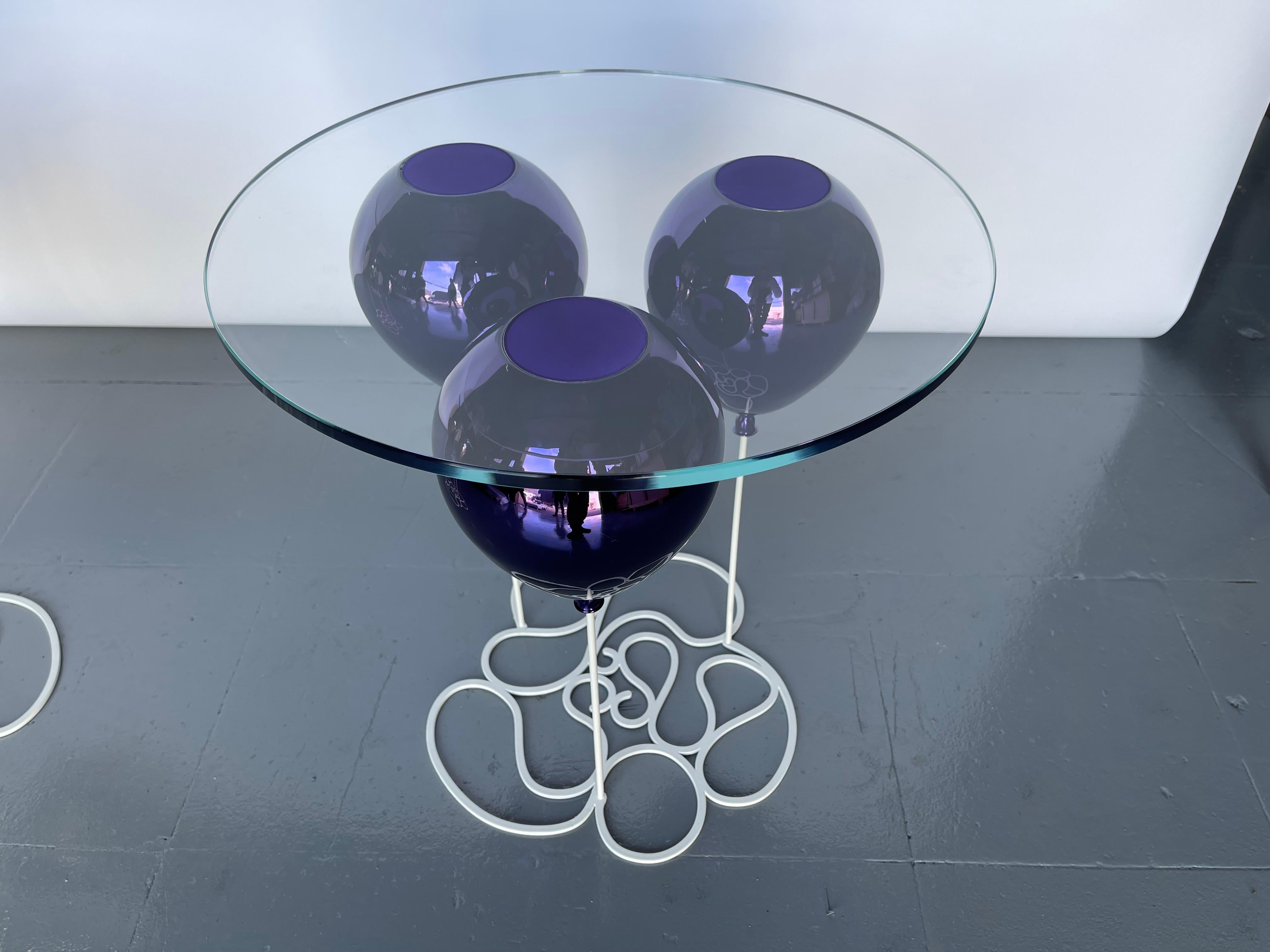 A post-modern, illusionary side table in a striking metallic purple finish from acclaimed British furniture designer Duffy London.

The UP! Balloon Side Table is a playful trompe l’oeil furniture piece. A trio of metallic, purple balloons impresses