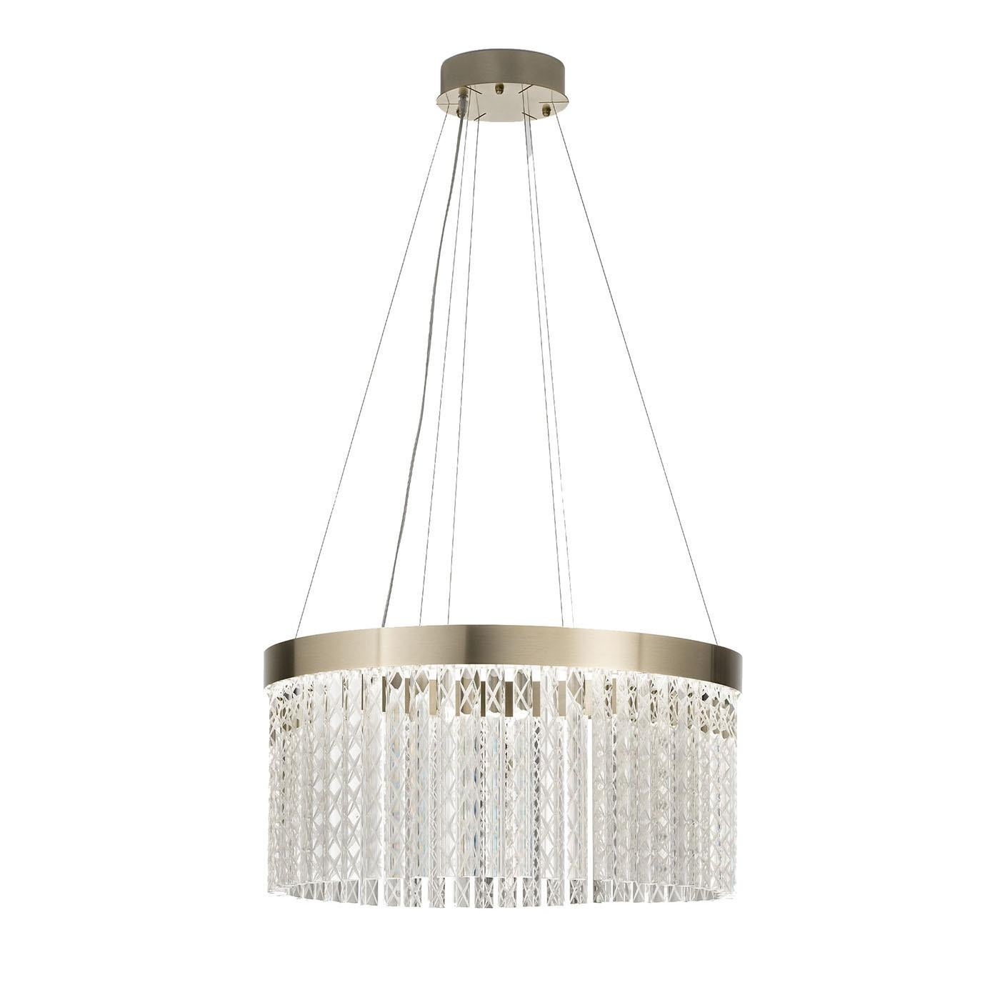 This designer chandelier features hand-engraved Triedro glass with a sophisticated rhombus pattern. Its circular, harmonious shape adds a touch of elegance to any space. Integrated LED lighting softly diffuses light, while the intricate engraving on