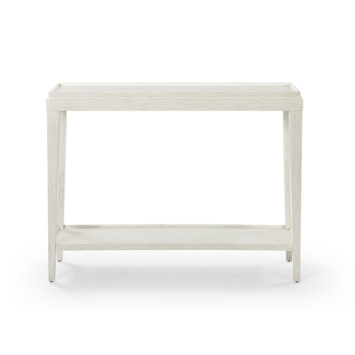 Crafted with a wooden galleried dish top and finished in a hand-rubbed with subtle distressing, this console table exudes a rustic yet refined aesthetic.

This beautifully crafted piece features a ‘drift’ white painted finish with subtle grey