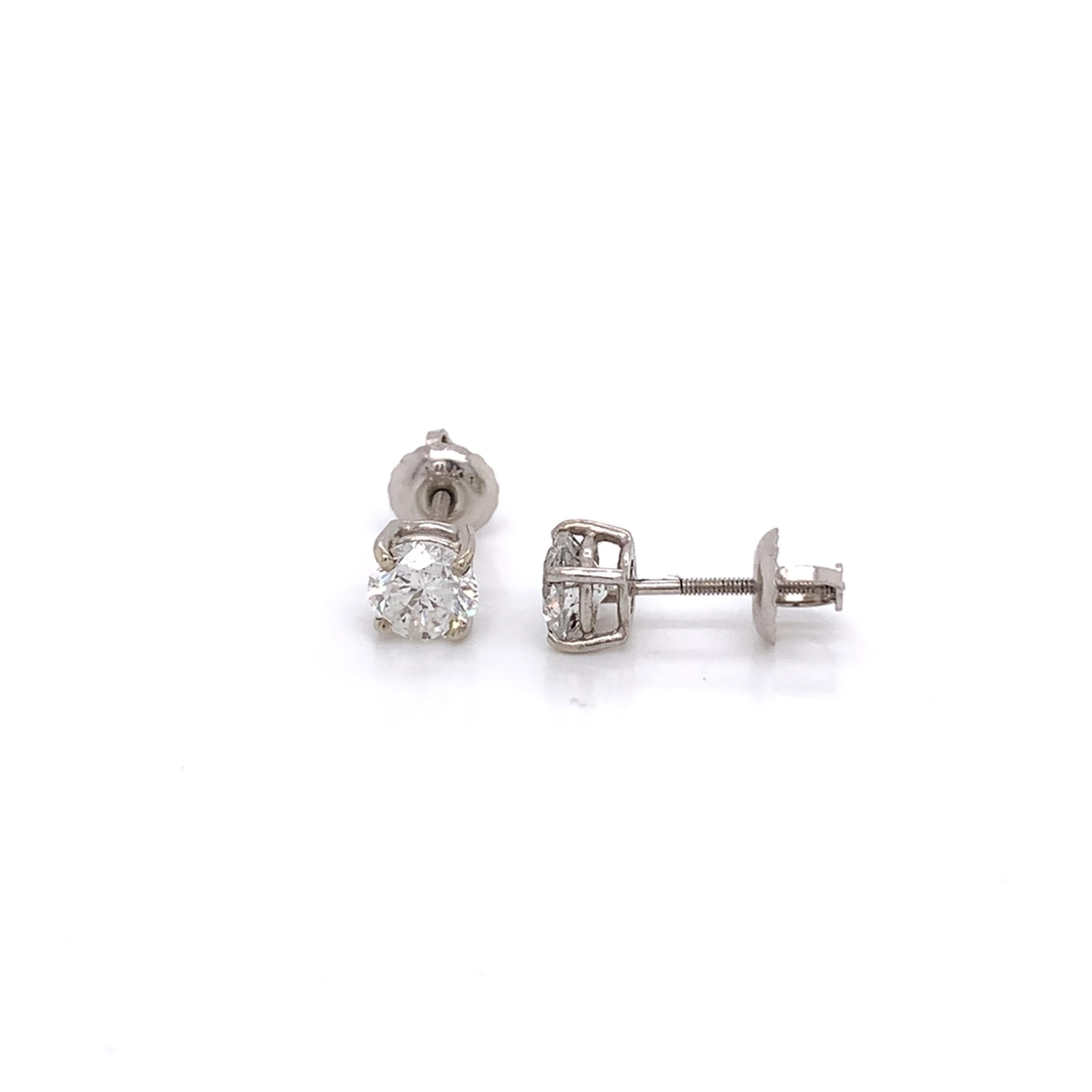 Diamond Stud earrings made with real/natural brilliant cut diamonds. Total Diamond Weight: 1.04 carats. Diamond Quantity: 2 round diamonds. Color: G-H Clarity: SI3. Mounted on 18 karat white gold screw-back settings.