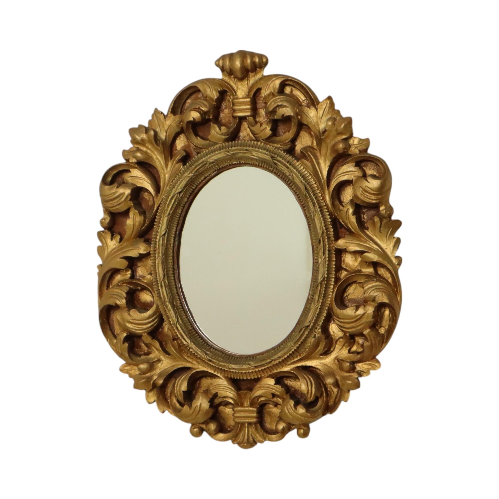 Small classic baroque style mirror, elaborately decorated with acanthus leaves and tendrils, France, second half of the 20th century.

Beautiful and elegant object, graceful acanthus leaves along the outside and a central ribbon and stripe pattern