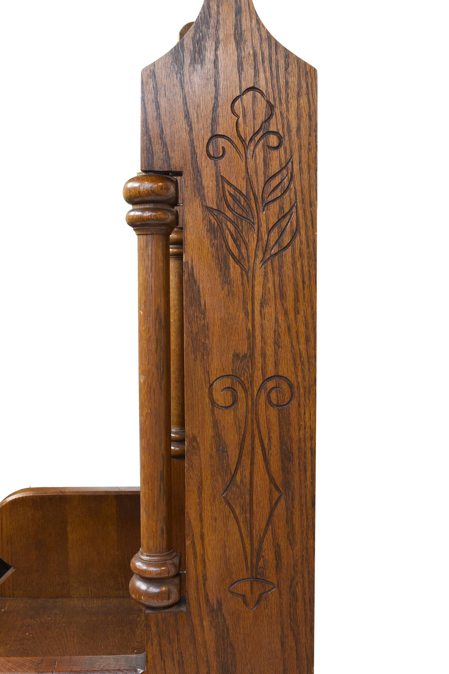 Ornate oak clergy chair with carved lilies on the side, spindles and fleur-de-lis adornments, and cross emblem, with quatrefoil cut-outs along the back,

circa 1920
Condition: Excellent
Finish: Original
Country of origin: USA

Measures: 57