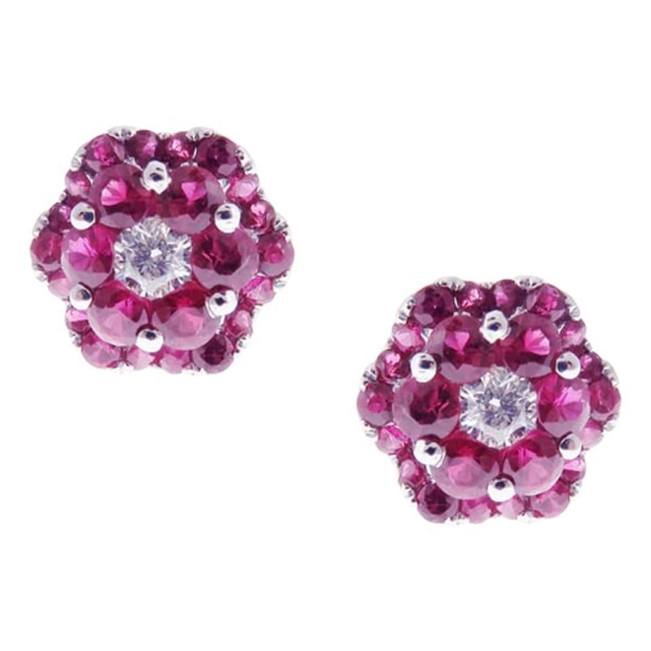 Small flower cluster ruby earring and ring set, all with a high polish finish. Available in 18K White Gold. 

Earring Information 
Diamond Type : Natural Diamond
Metal : 18K
Metal Color : White Gold
Diamond Carat Weight : 0.20ttcw
Rubies Carat