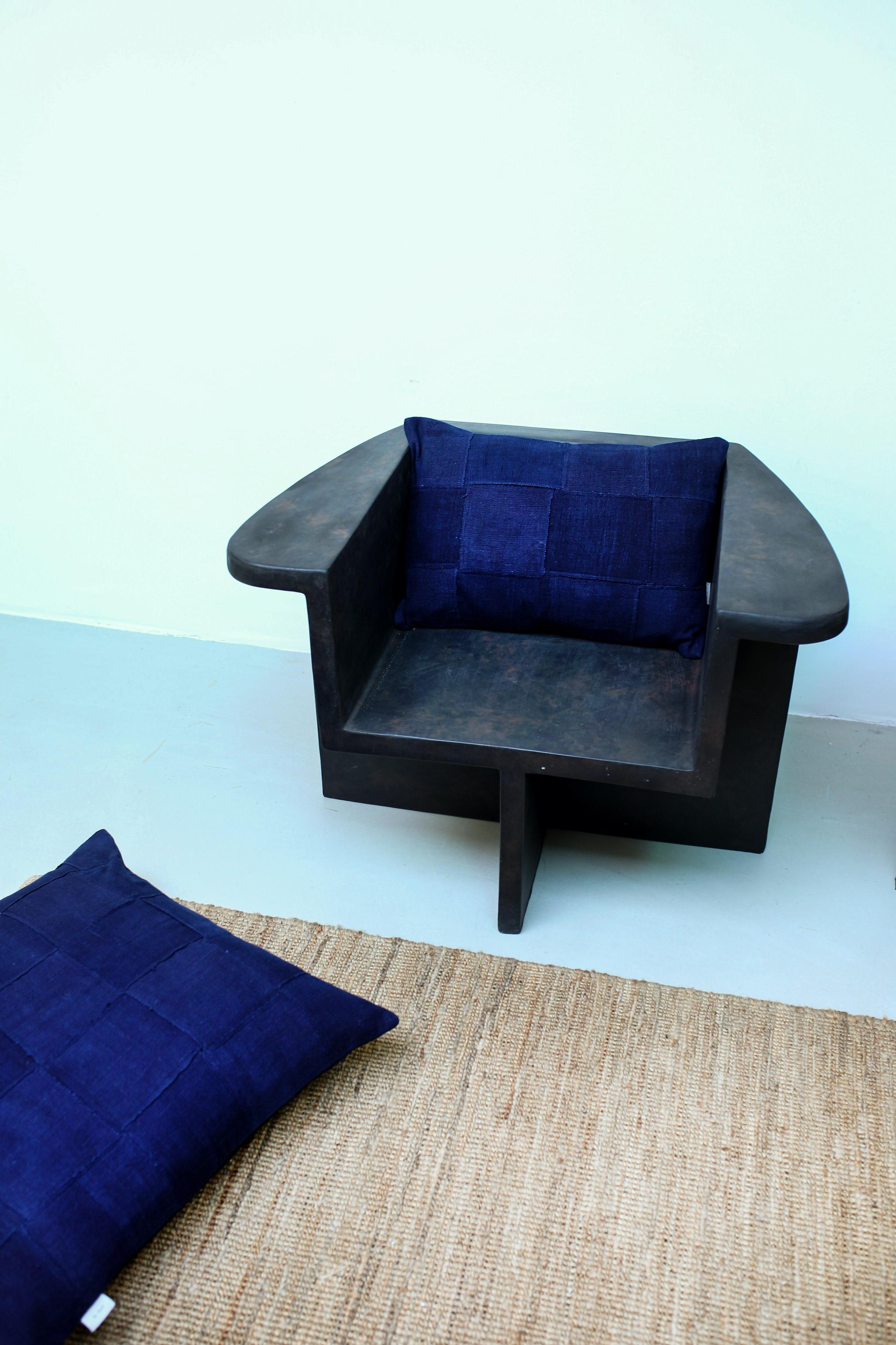 This Indigo glue fabric is handwoven and plant-dyed in the Dogon region of Mali. The cotton is traditionally handpicked, spun and woven into small strips, which can still be seen in this cushion. The brown color in this cushion is derived from