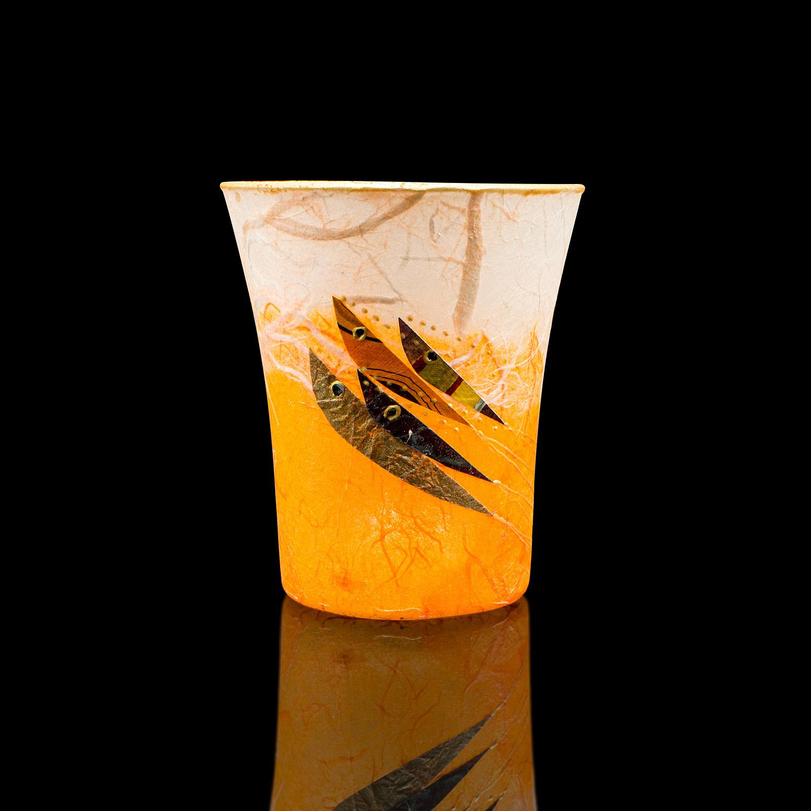
This is a small contemporary posy jar. An English, art glass and straw silk vase or tea light holder by Margaret Johnson.

Appealing colour and fish motif attracts the eye
Displays a desirable, contemporary appearance
Colourful glass beams in the