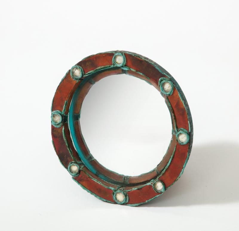 Small Convex Copper Mirror in the Manner of Line Vautrin, France, c. 1960

A very unique looking mirror with a deep red copper frame and white glass decorations rimmed in turquoise blue.

Reminiscent of mirrors designed by Line Vautrin in the later