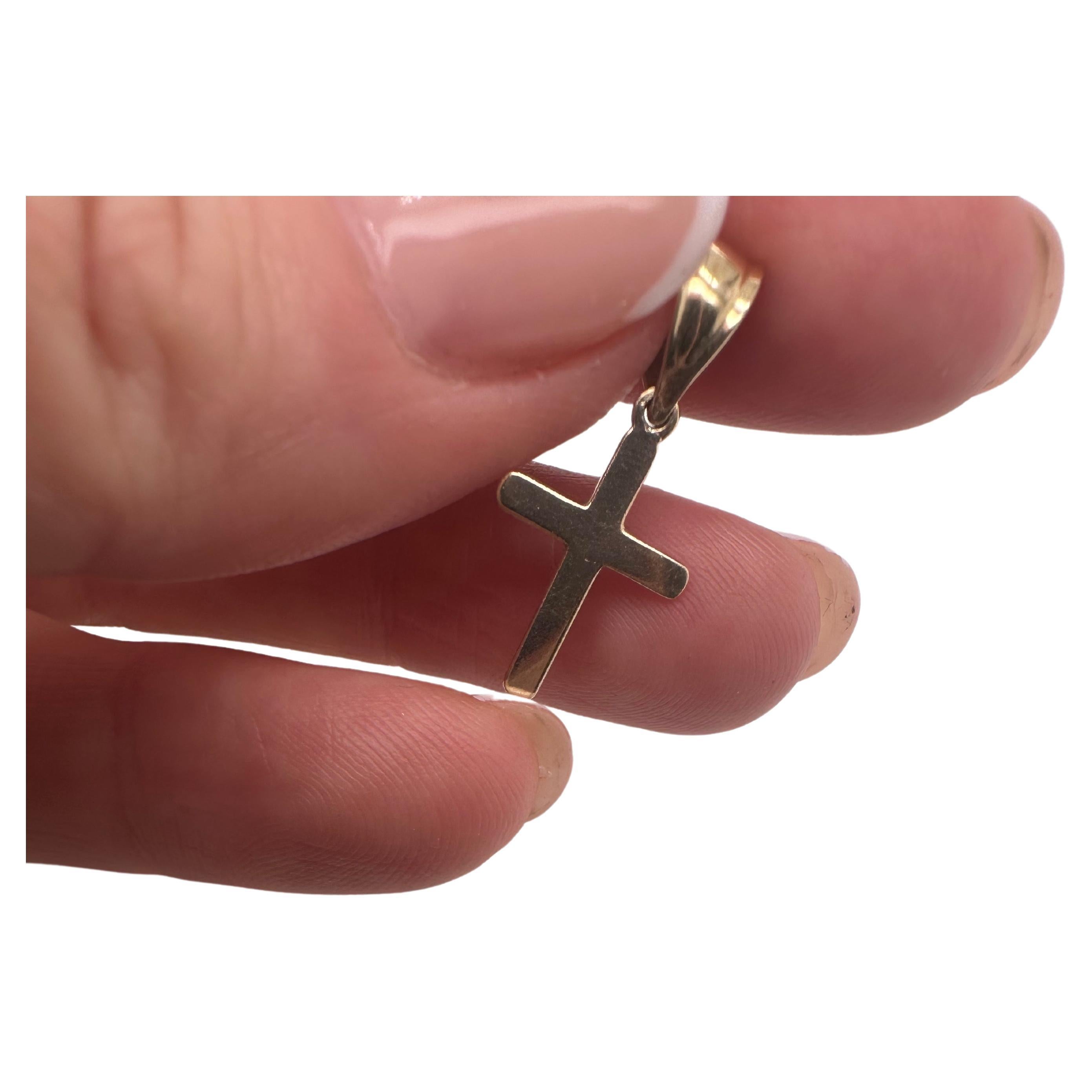 Small cross with a large bail, this is meant for a mens gold chain that wants to wear a cross but not too huge so the bail can fit most chains and it will create a humble look on the gold chain with a small cross on the chain. The cross is simple