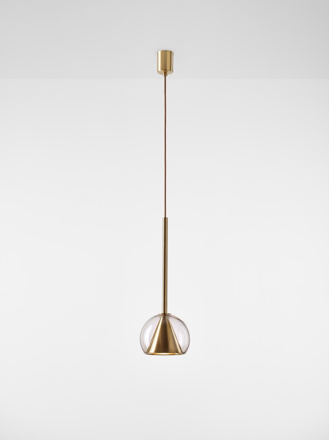 Small Crystal Clear Kono pendant light by Dechem Studio
Dimensions: D 19 x H 52 cm
Materials: Brass, Glass.
Also Available: Different finishes and colours available.

This collection of suspended light fixtures combines the elementary geometric