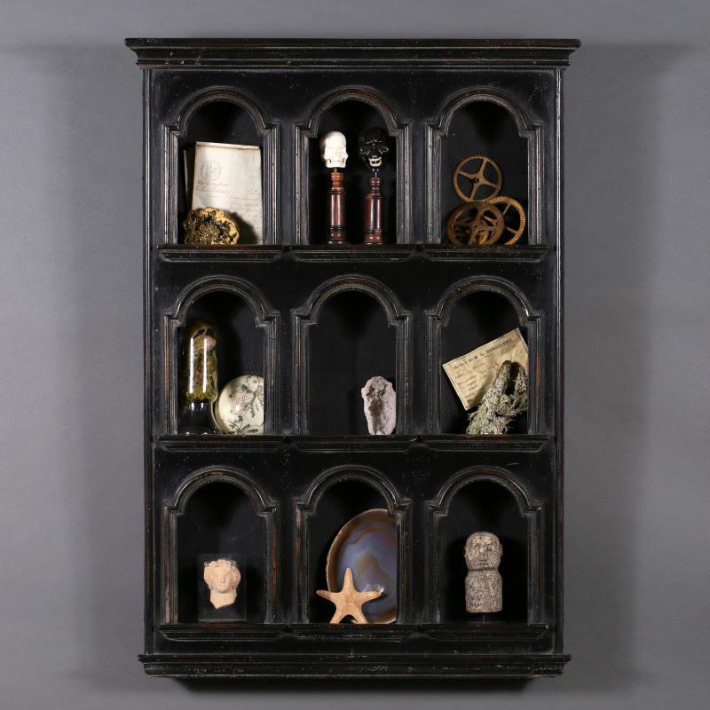 Small Curiosity Wall Cabinet or Small Library, 20th century.

Small library, wall unit for curiosities in blackened wood with 9 alcoves in the antique style, 20th century.
H: 88cm, W: 63cm, D: 11cm