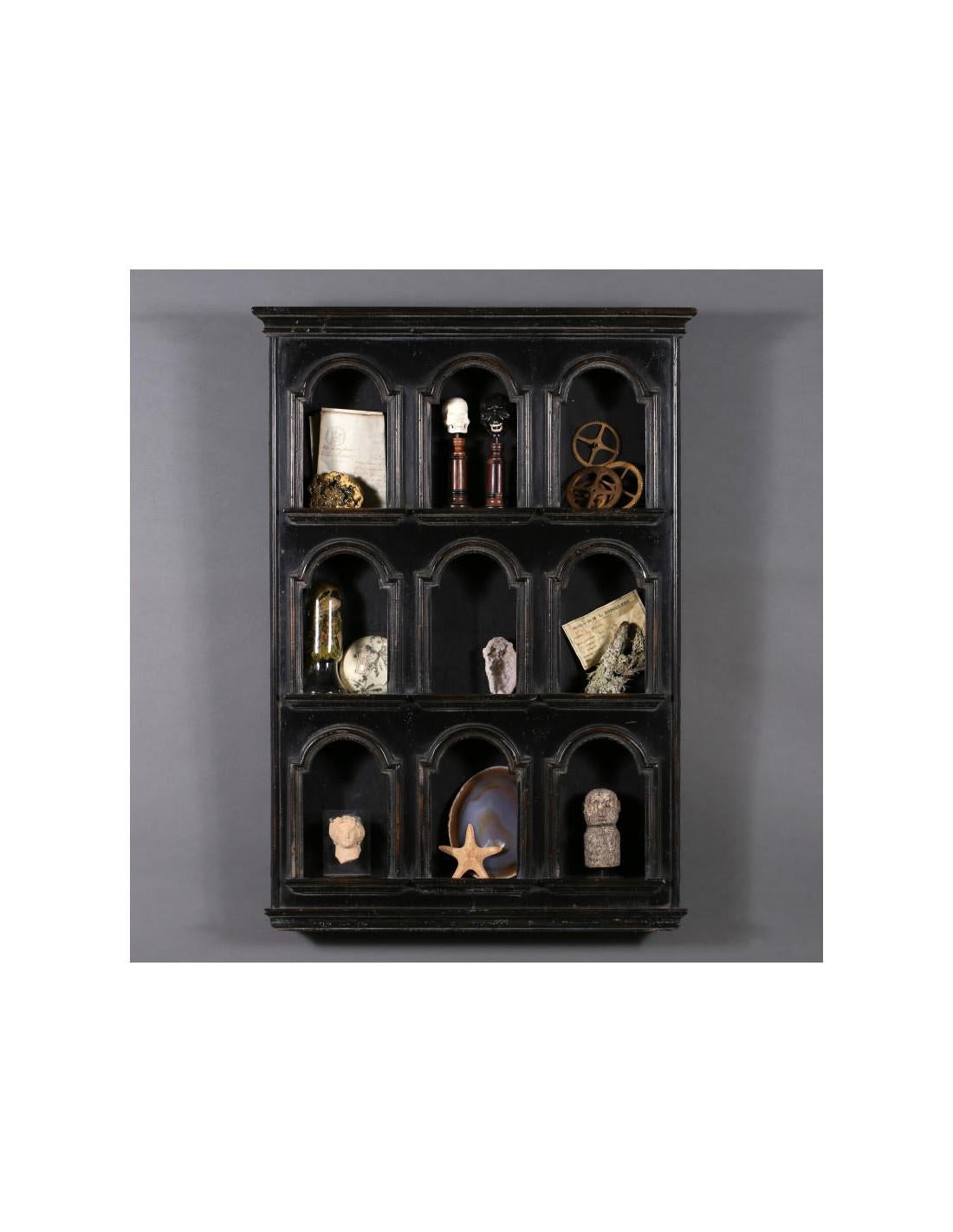 Small Curiosity Wall Cabinet or Small Library, 20th century.

Small library, wall unit for curiosities in blackened wood with 9 alcoves in the antique style, 20th century.
H: 88cm, W: 63cm, D: 11cm