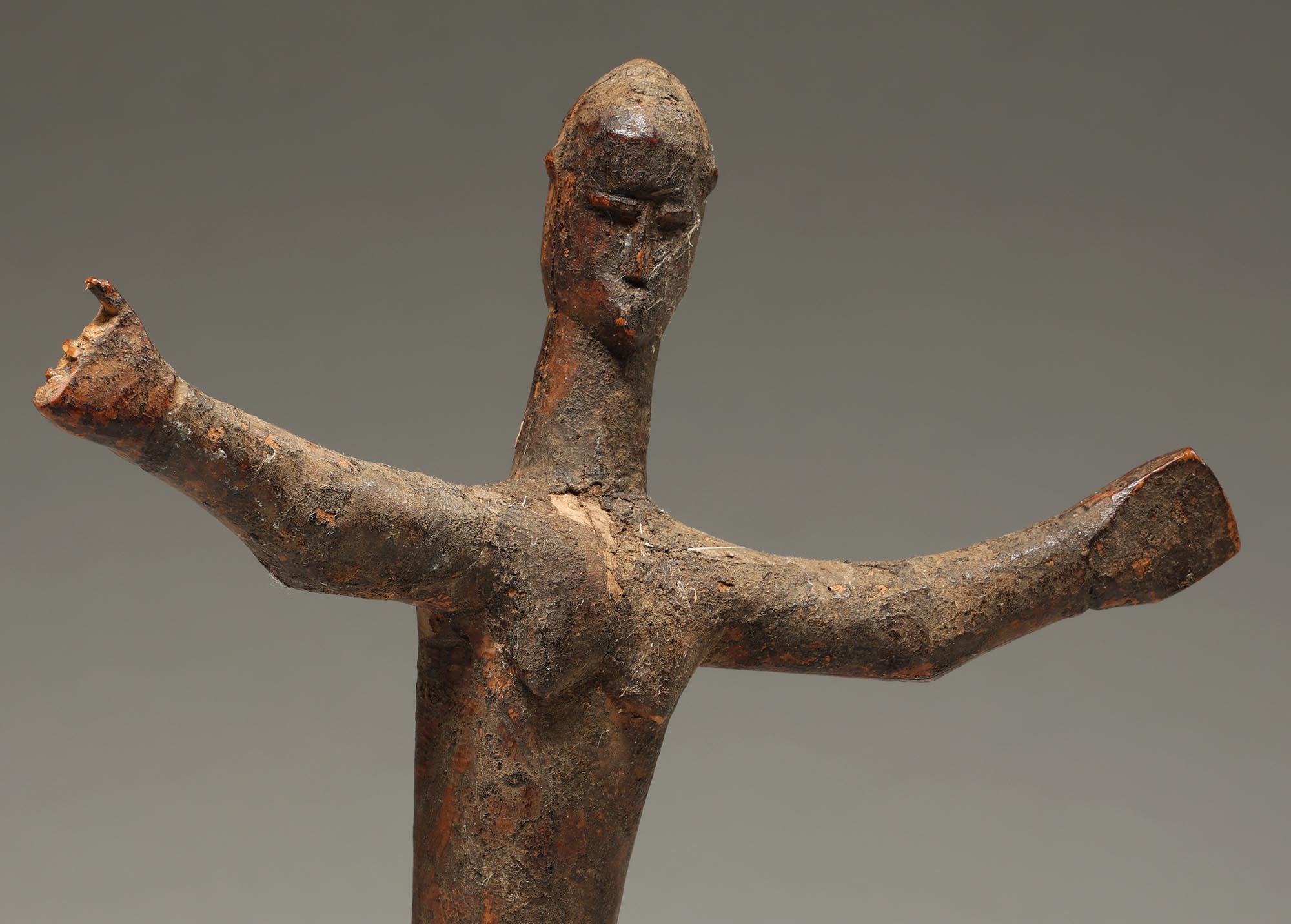 Small dancing Lobi figure with arms out, and cubist face from Ghana, West Africa. ex James Willis, San Francisco, CA.  Damage to proper right hand, fingers absent.  Heavy encrusted patina from ritual use in a shrine.  Wonderful movement and