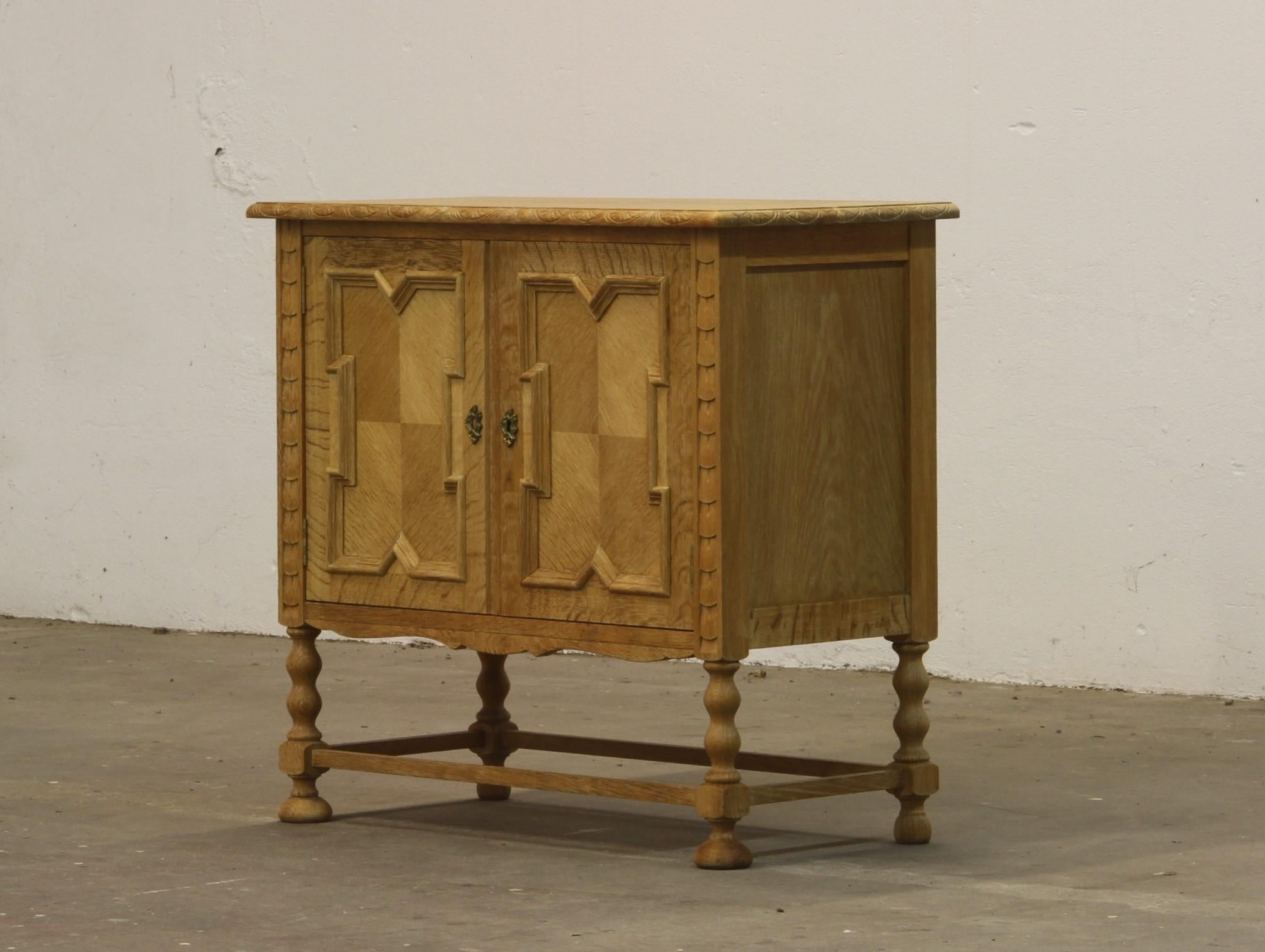 
A Danish Mid-Century Modern cabinet crafted from Nordic oak, made in Denmark during the 1960s and often attributed to renowned designer Henning (Henry) Kjærnulf. Kjærnulf is celebrated for blending Scandinavian Modern aesthetics with medieval,