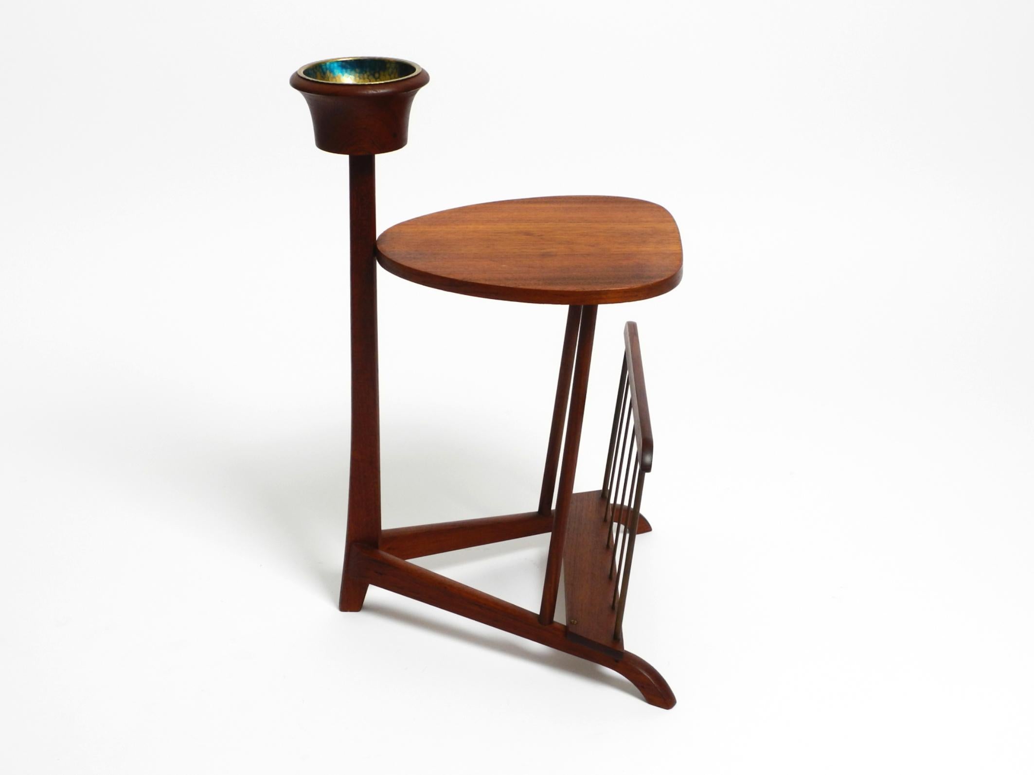 Beautiful rare small Mid Century teak side table with magazine compartment and ashtray.
Made in Denmark. Great Scandinavian design. Made in the 1960s.
Removable brass ashtray insert. Very clean, never used as an ashtray.
Very nice minimalist design