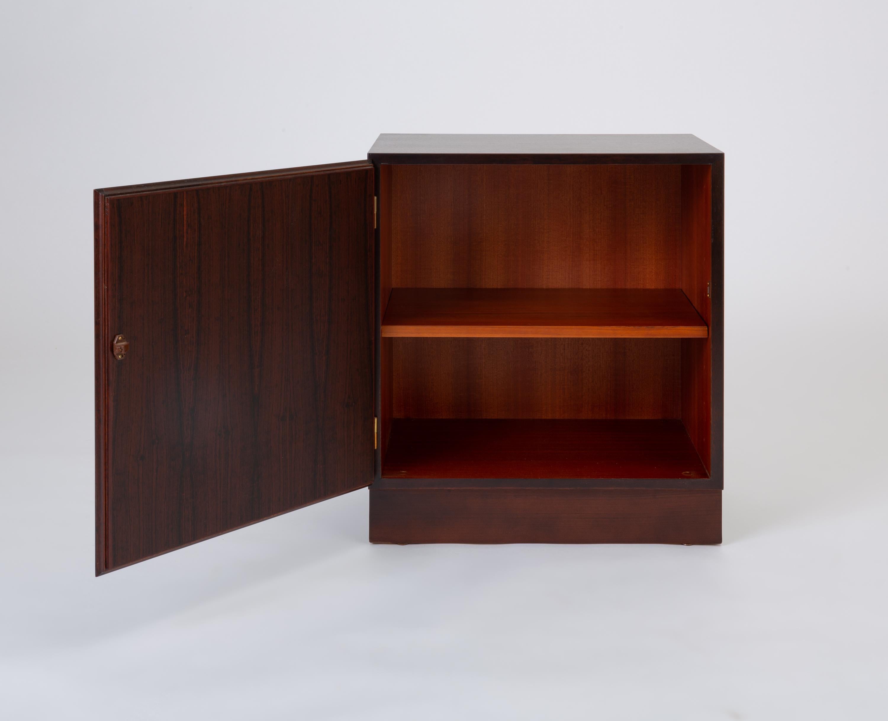A 1970s rosewood cabinet from the Classic collection by Omann Jun. The modest storage model was designed to work as a standalone piece or in conjunction with other Classic modules to form a larger cabinetry system. This example has a simple rosewood