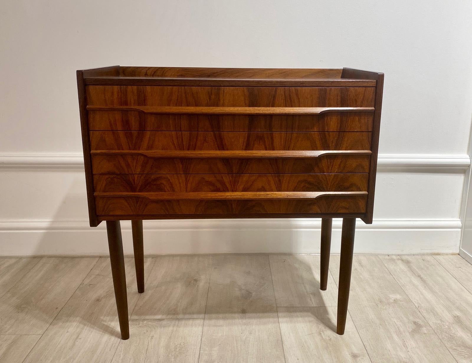 Beautiful 1950s Danish cupboard of lovely petite proportions sat on tall thin legs with three drawers.

Really stylish side table with beautiful rosewood color and grain.