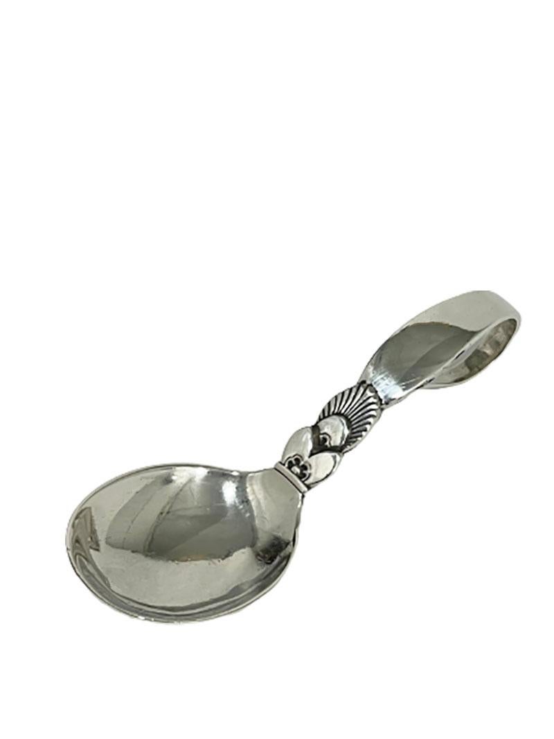 Small silver Georg Jensen sugar/ tea caddy spoon, 1932.

The spoon in Model cactus with curved final, marked with the Danish silver hallmarks of Georg Jensen, used during 1915-1932
The three tower mark with year number 1932
The CHF mark or