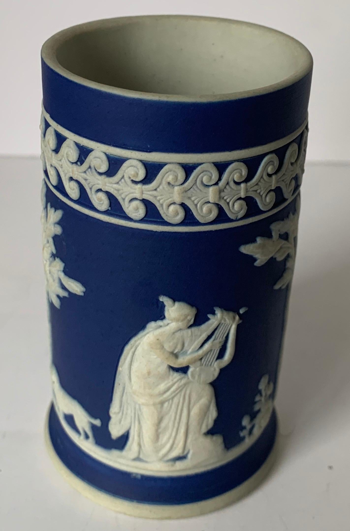 Small dark blue Wedgwood jasperware spill vase. Overall neoclassical motif. Stamped on the underside.
