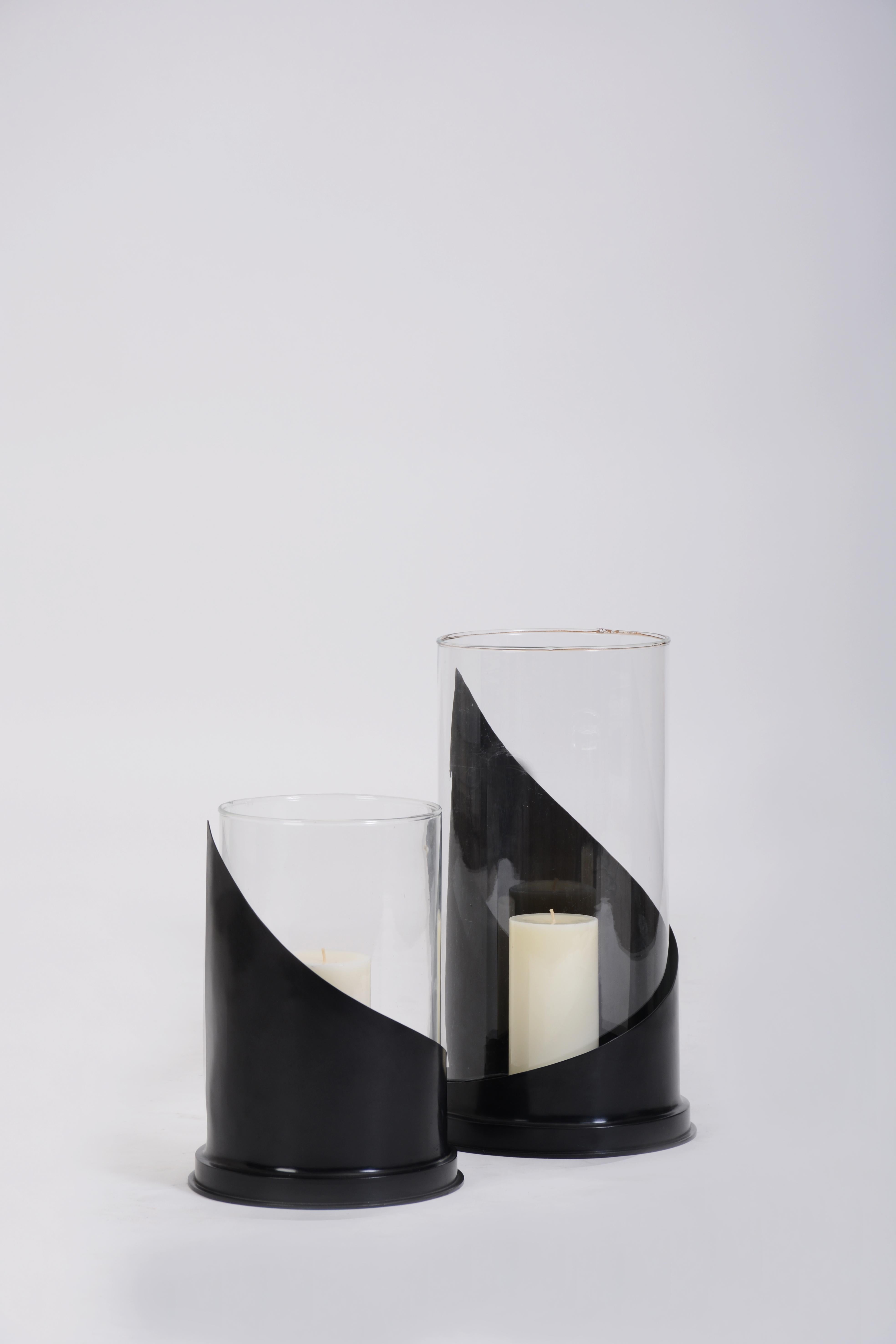 Hurricane in lost-wax cast-bronze with glass shade from Elan Atelier. In stock and ready to ship.

The Olivia is adept at creating a subtle effect – selectively engaging and shielding candlelight from the eye as a viewer moves throughout a
