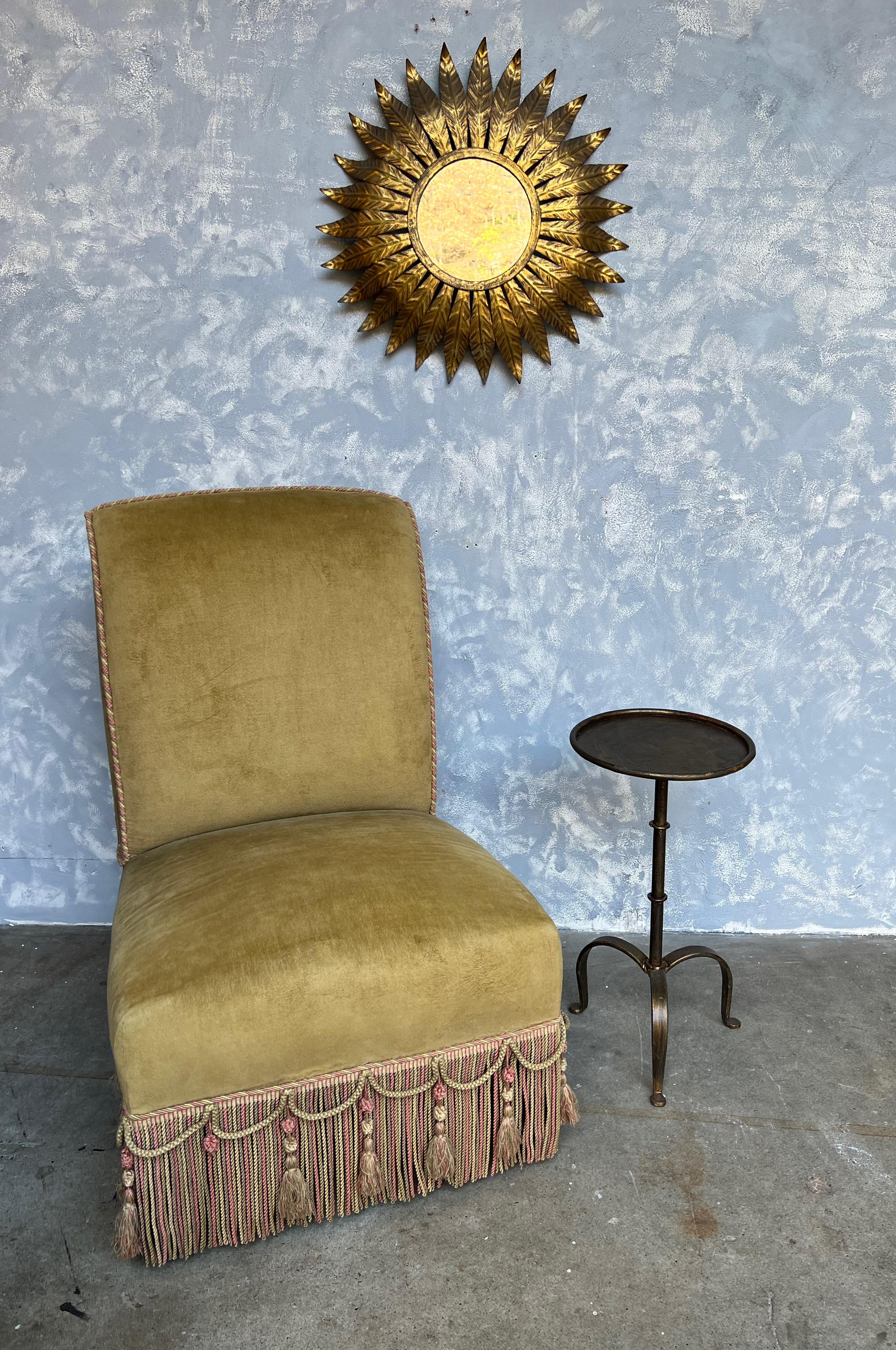 This small iron and metal end table from Spain, dating back to the 1950s, is a charming piece of vintage furniture. It boasts a sturdy tripod base and a central ring detail on the stem, offering a combination of stability and visual intrigue.