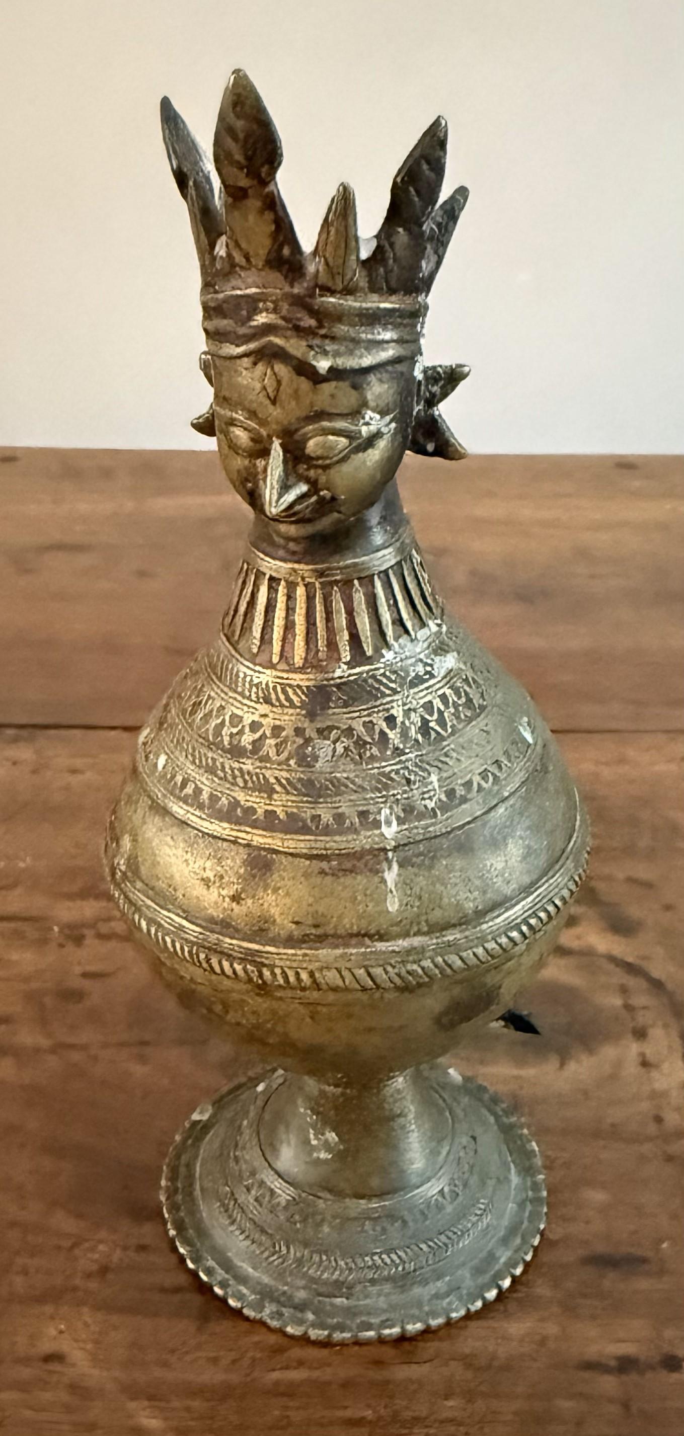 Small decorative Brass Hindu urn with a crowned head and intricate cast details. Made in India circa 1750. Possibly used for incense on a shrine.

A rare and characterful small brass urn from India, made circa 1750 and likely intended for ceremonial