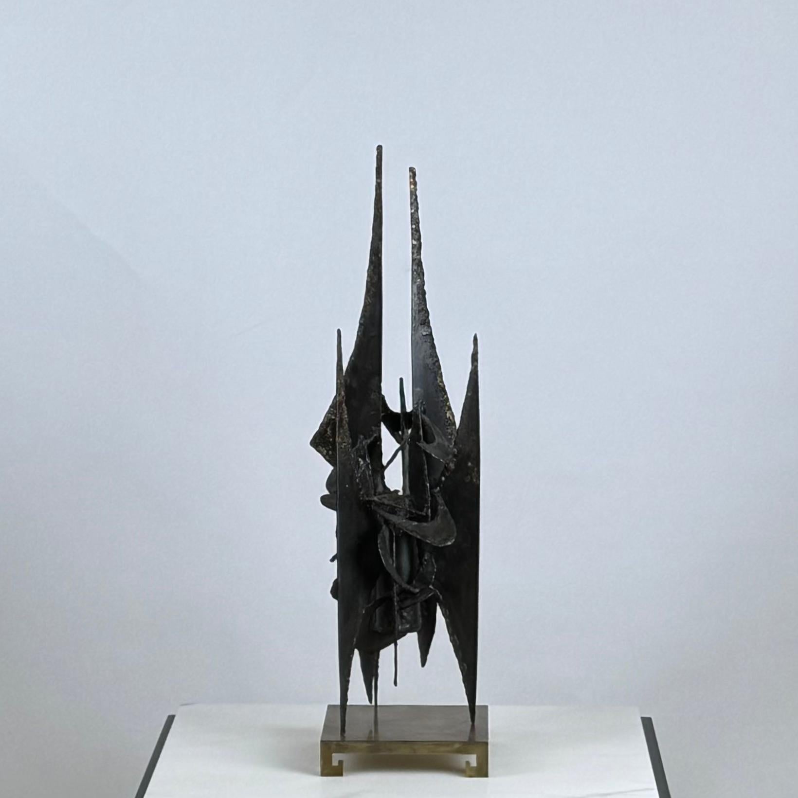 Striking mid-century brutalist sculpture on brass stand featuring bold, abstract geometry and raw, textured metalwork.
This piece has a great patina and every side is its good side.
Sold as a set (sculpture and stand together).