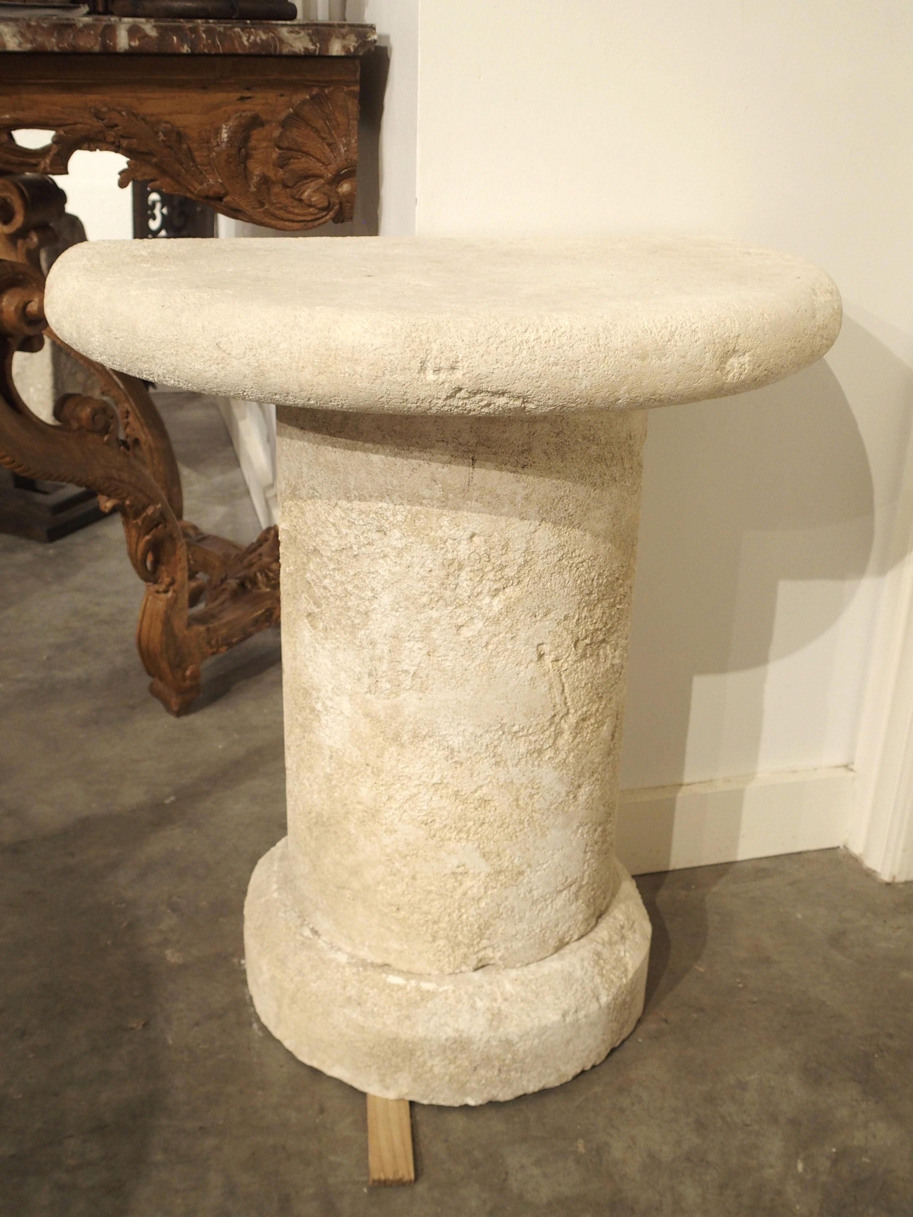 From Provence, France, this small demilune console table has been hand-carved from limestone in three sections. The two-and-a-half-inch thick top sits on top of a three-quarter column above a four-and-three-quarter thick demilune base with beveled