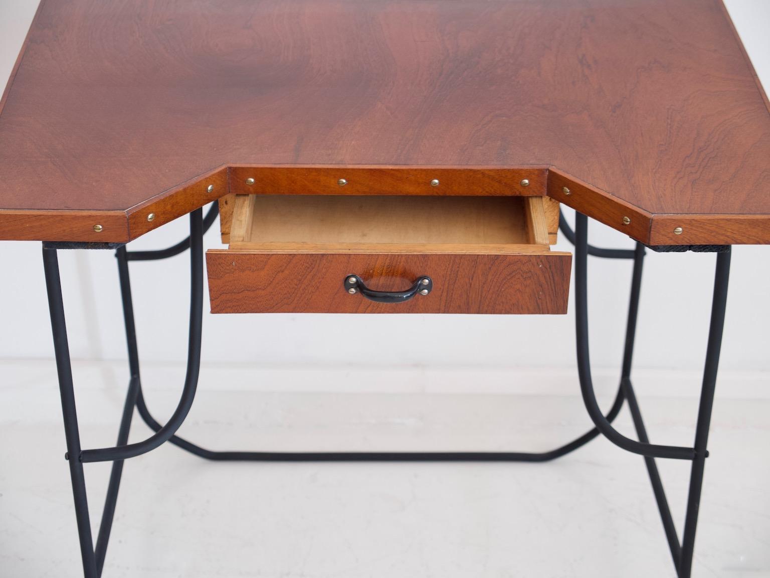 Desk or a side table from circa 1930-1940. Top veneered with mahogany, front with single drawer. Black painted steel frame.