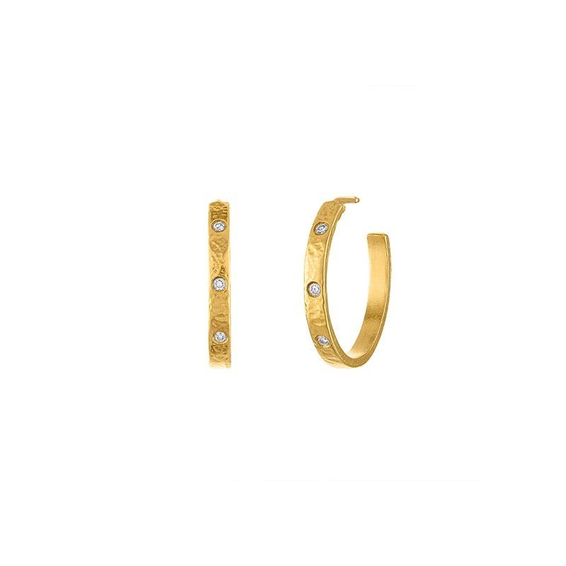 These one-of-a-kind hoops boast a beautiful interplay of texture and sparkle. Crafted from rich 22k gold, each earring features a lightly hand hammered finish that adds depth and dimension. Delicate diamonds, securely set in bezels, add a touch of
