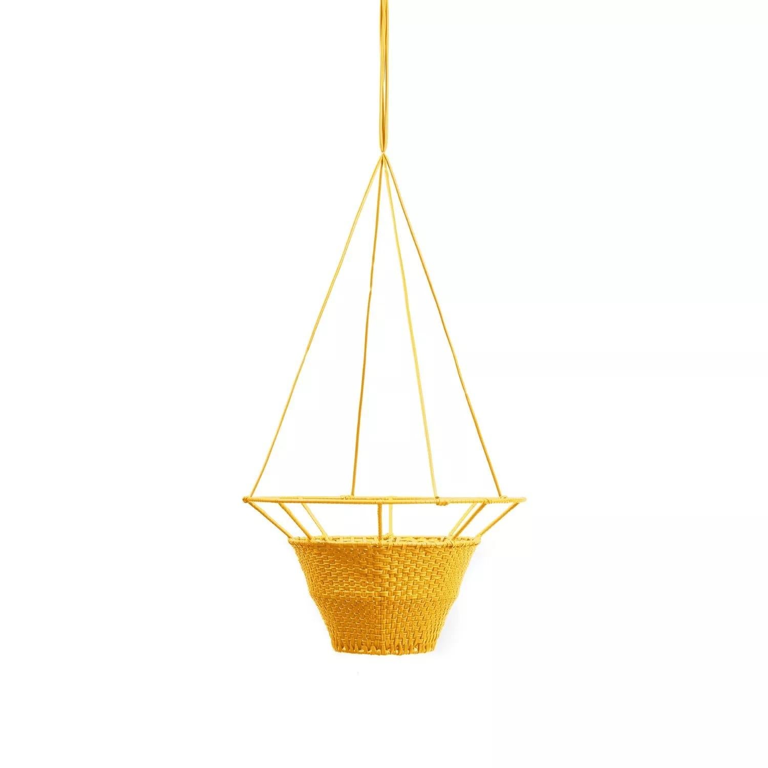 Small dichas hanging planter by Cristina Celestino. 
Materials: PVC strings made from recycled plastic
Dimensions: D 40 x H 17 cm 
Available in colors: black red, honey yellow, olive green. Available in other size.

The Dichas Hanging Planters