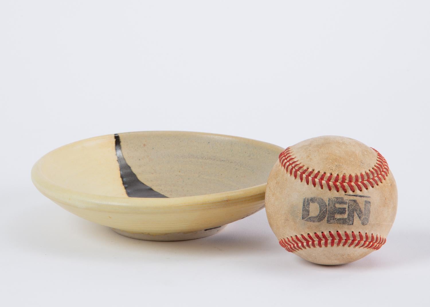 A small Studio Pottery dish by significant 20th century ceramicist Otto Heino. This example features the buttery yellow glaze Heino perfected after his wife’s death, a continuation of her long running project to reproduce a lost glaze recipe from