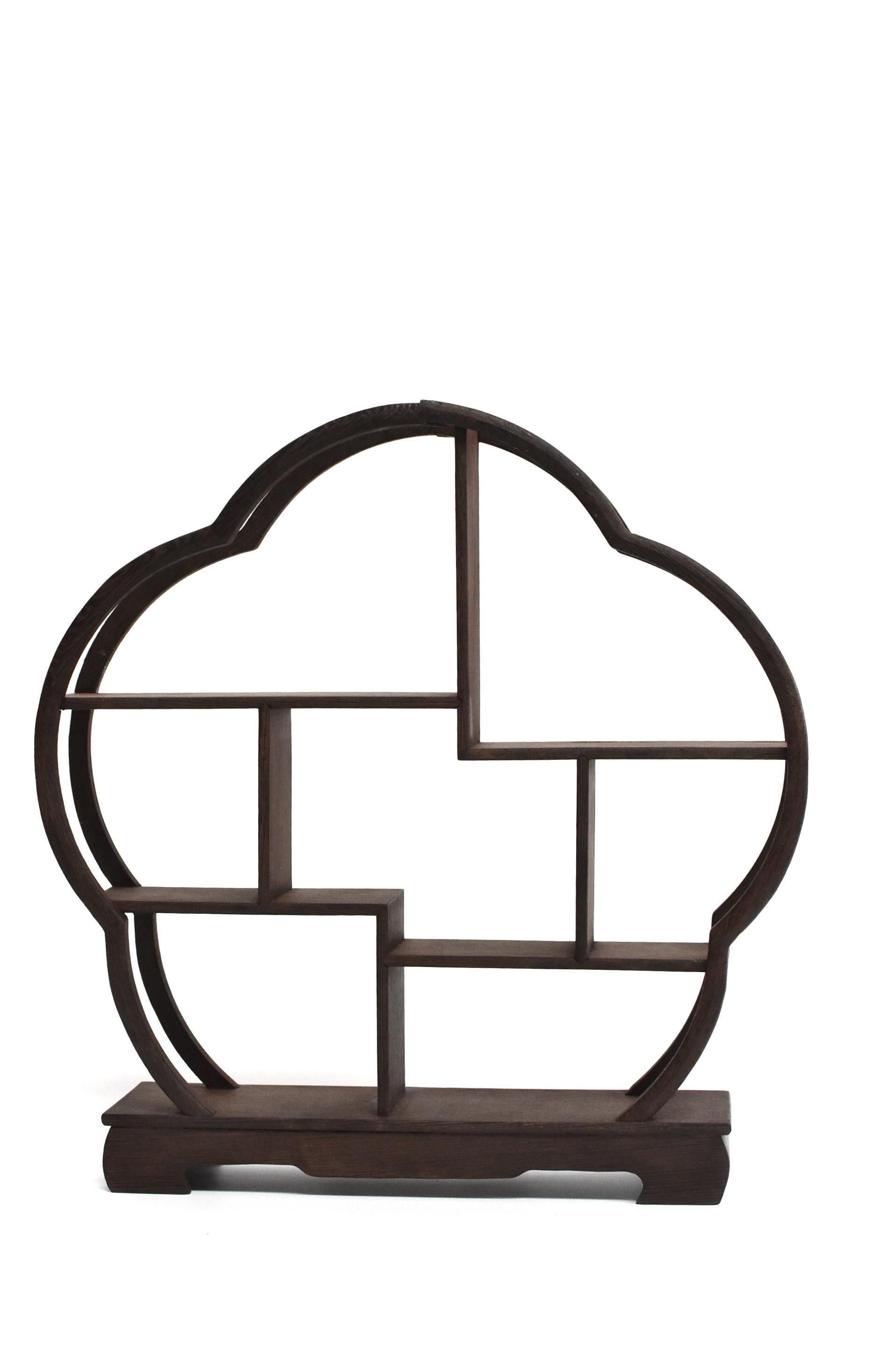 A fine ji-chi-mu solid wenge wood stand for display of your miniature collections. Beautiful, elegant begonia shape. There are eight spaces of various heights and sizes to suit your little treasures. The wood is beautiful with distinctive swirls and