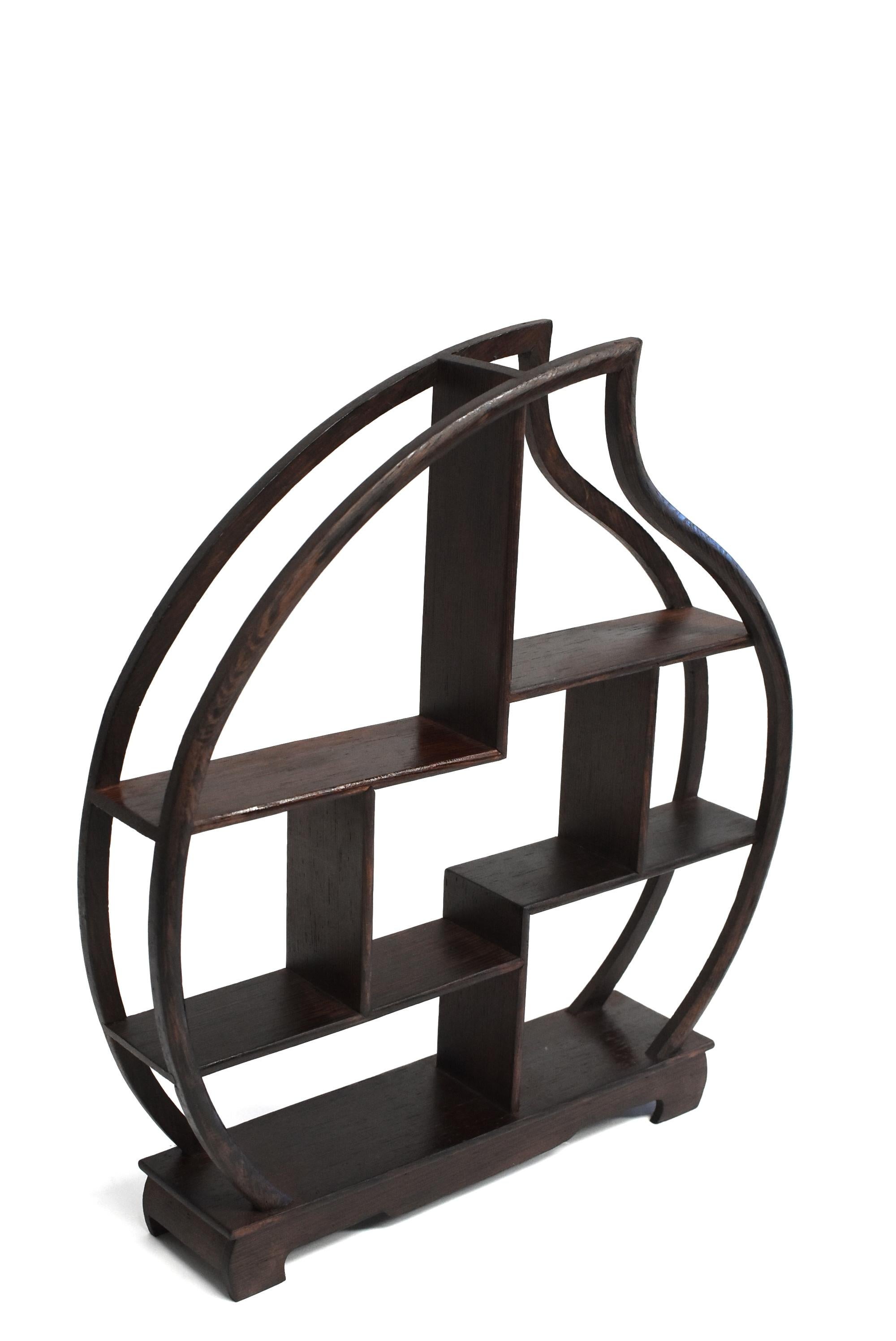 A fine ji-chi-mu solid wenge wood Stand for display of your miniature collections. Beautiful, elegant peach shape. There are eight spaces of various heights and sizes to suit your little treasures. The wood is beautiful with distinctive swirls and