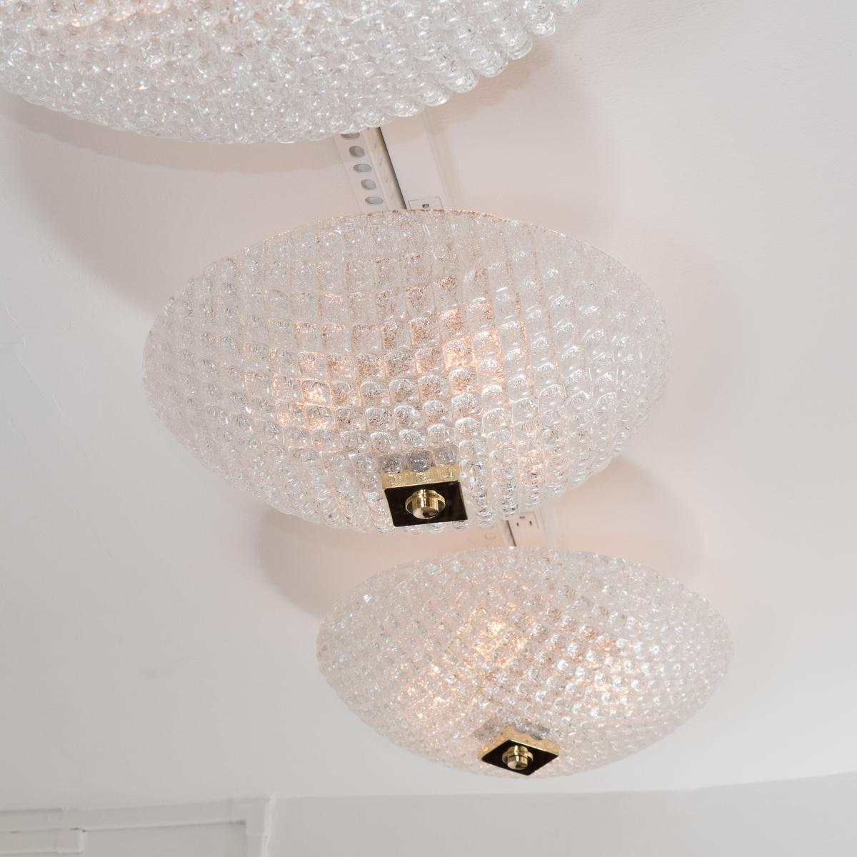 Small dome form textured glass flush mount fixture with brass finial.