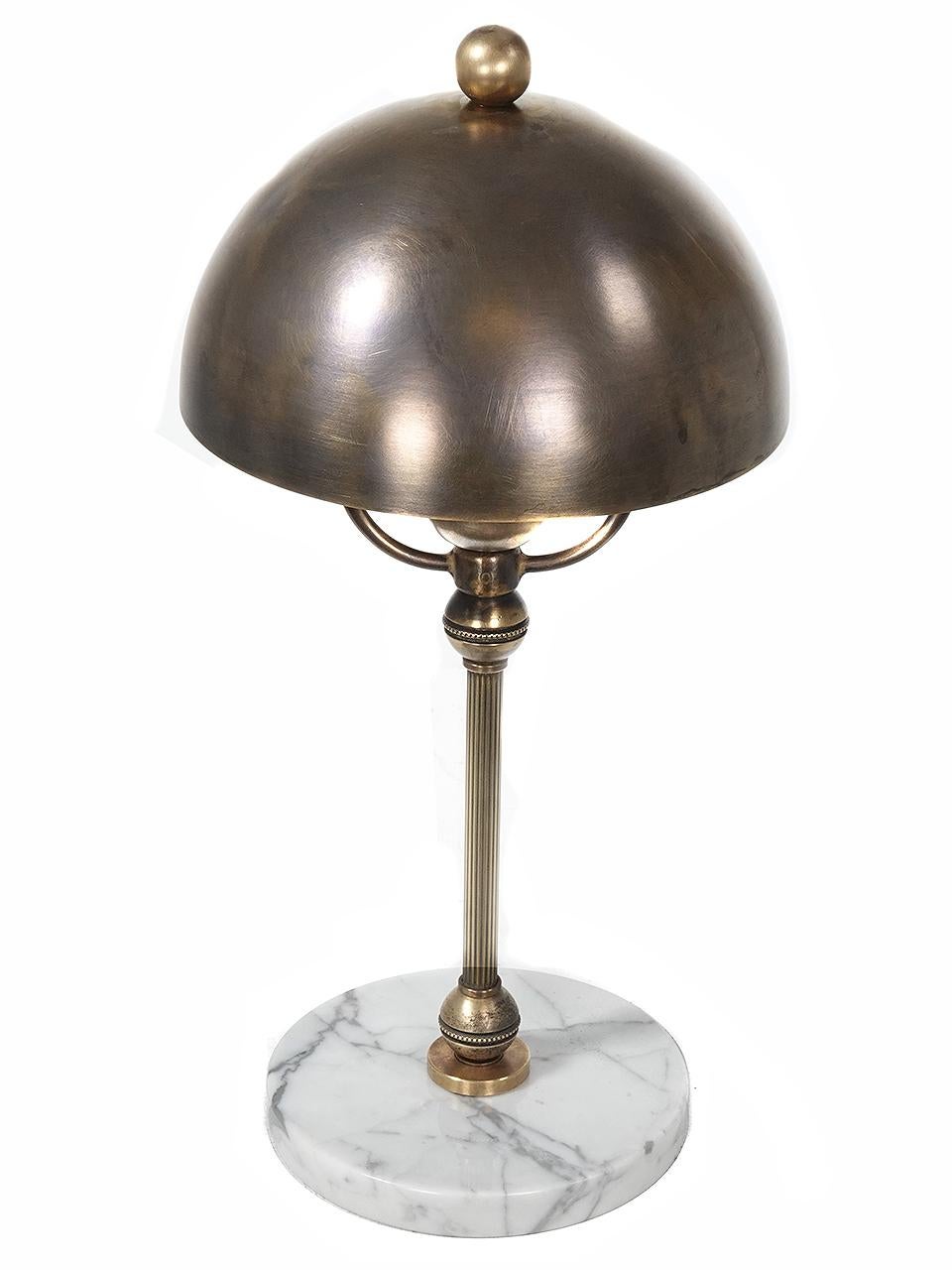 This is a very simple and elegant brass and marble desk lamp. It feels early and modern at the same time. The design is Classic upscale and feels comfortable with all styles of decor. It is very well made in and hand finished in heavy brass and