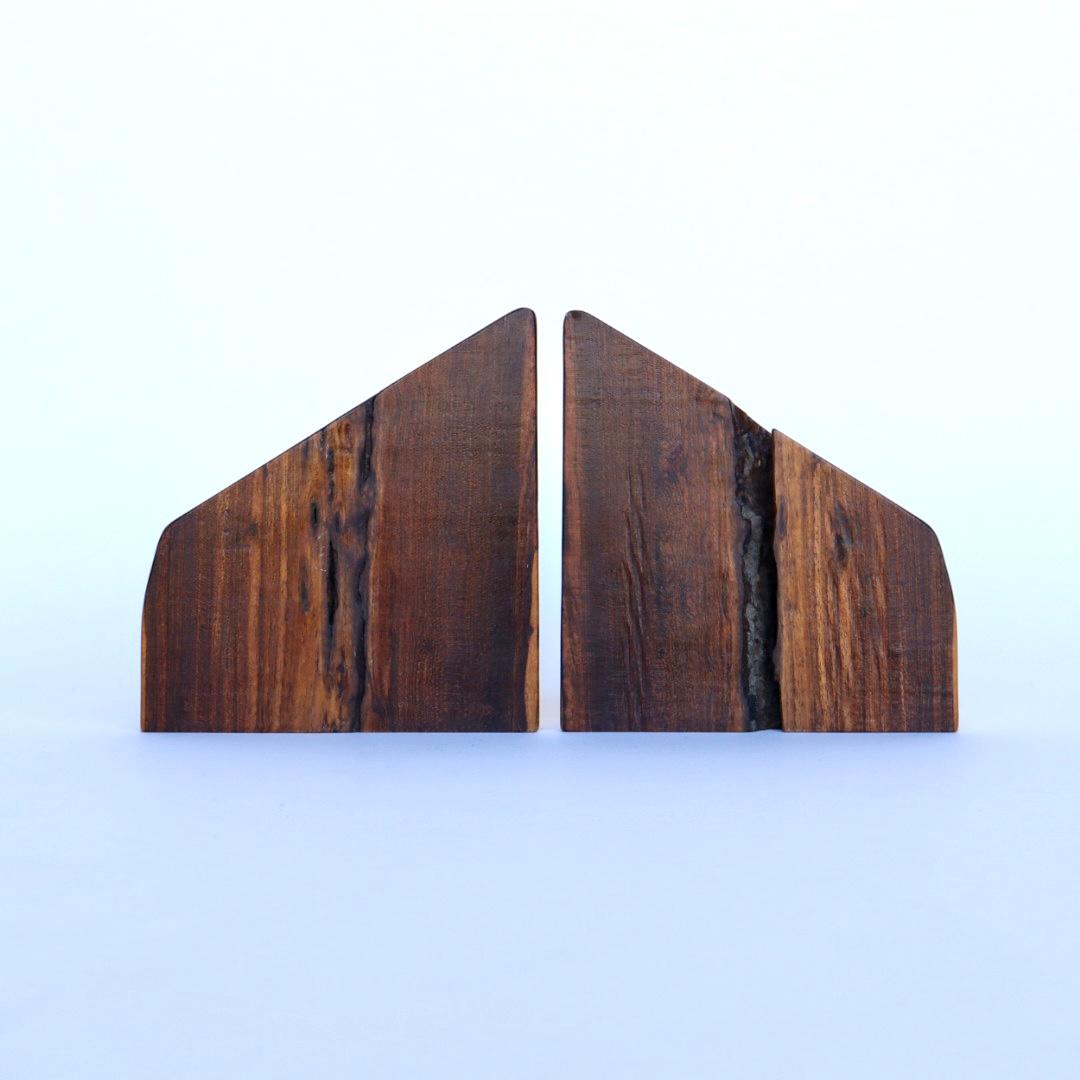 A pair of solid wood bookends by Mexican-American designer Don Shoemaker for his company, Señal. Rendered in highly figured cocobolo wood, a species of local tropical wood with a similar look and grain patter at brazilian rosewood, the bookends