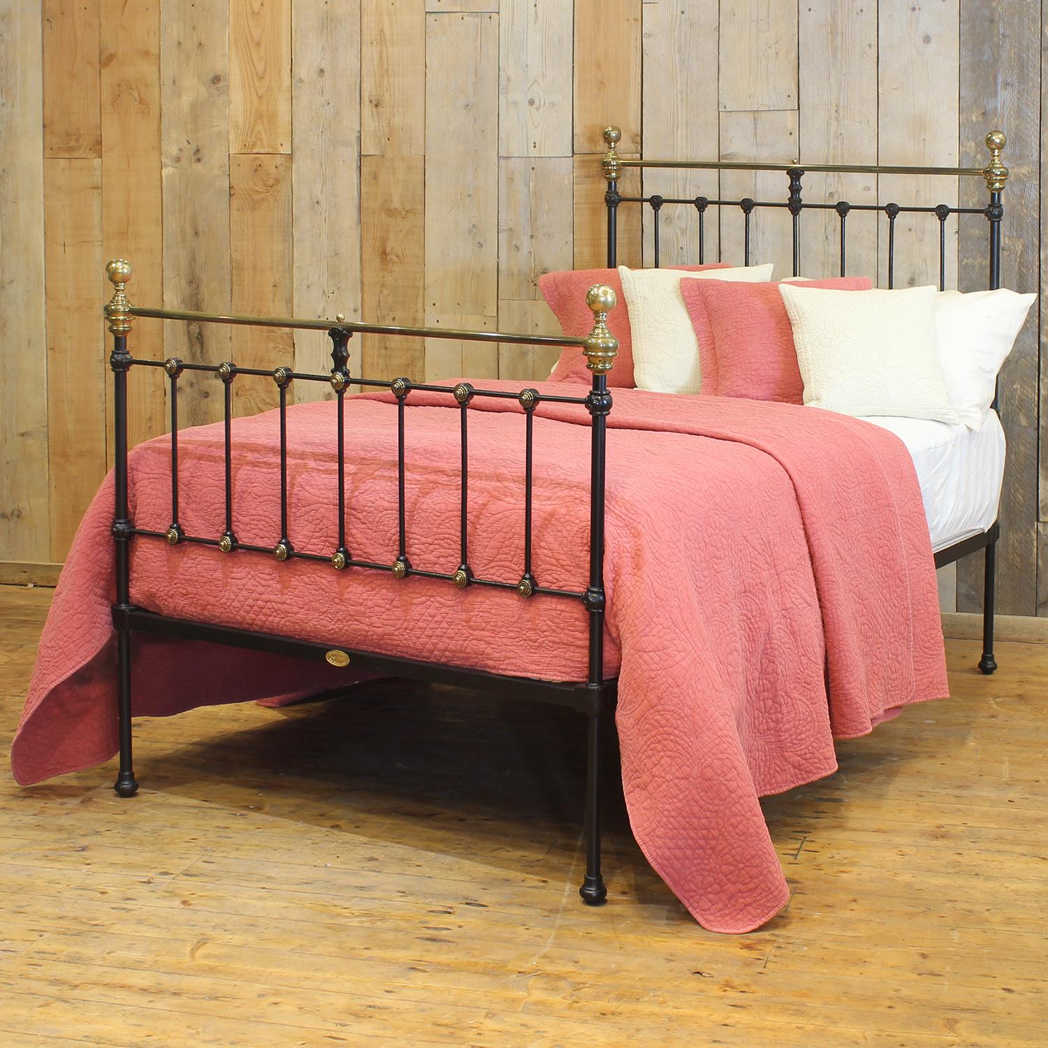 A small double Victorian cast iron and brass bedstead finished in black with straight brass top rails, spherical brass knobs and rosette decoration.

Elegant and timeless, this exquisite Victorian small double bed (4ft wide) dates from around 1895.
