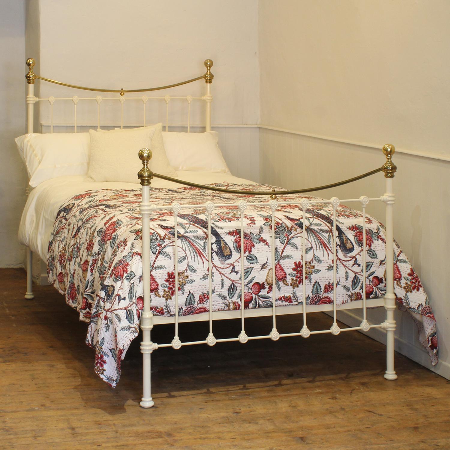 A small double Victorian cast iron and brass bedstead finished in cream with curved brass top rails and attractive castings.

This bed accepts a small double size 4ft wide (48 inch or 120cm) base and mattress. 

The price includes a firm standard
