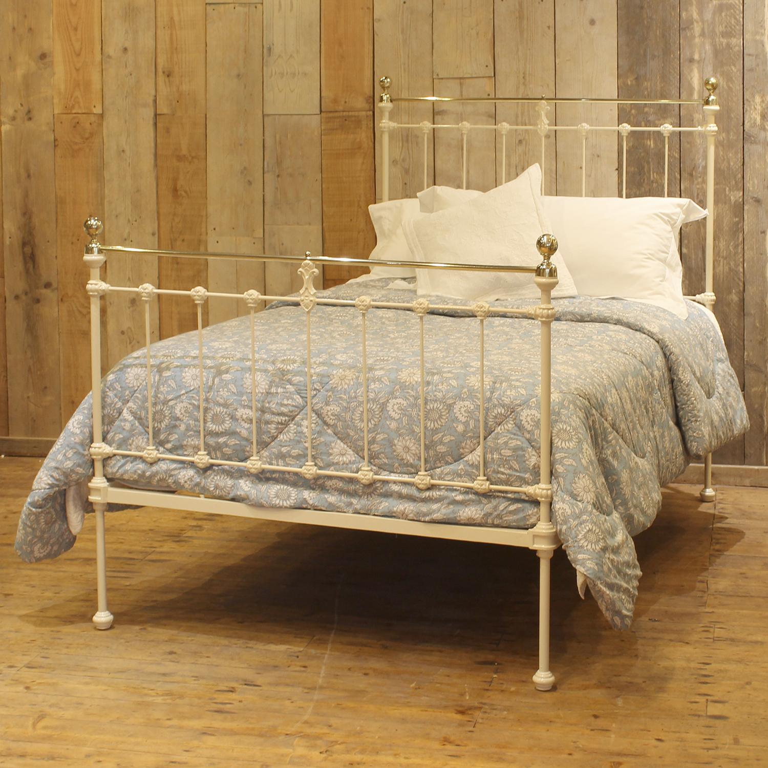 A small double Victorian cast iron and brass bedstead finished in cream with straight brass top rails, cap collars, spherical brass knobs and attractive castings.

This bed accepts a small double size 4ft wide (48 inch or 120cm) base and mattress.